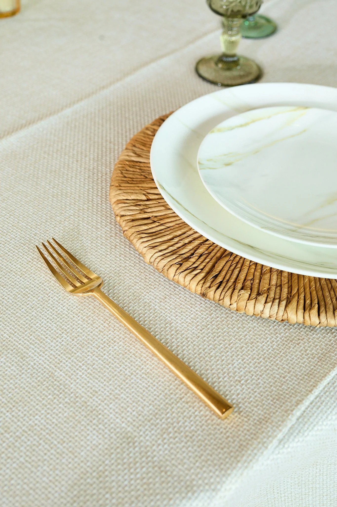 Four people toasting with colorful drinks on a balcony, with urban buildings in the background.
