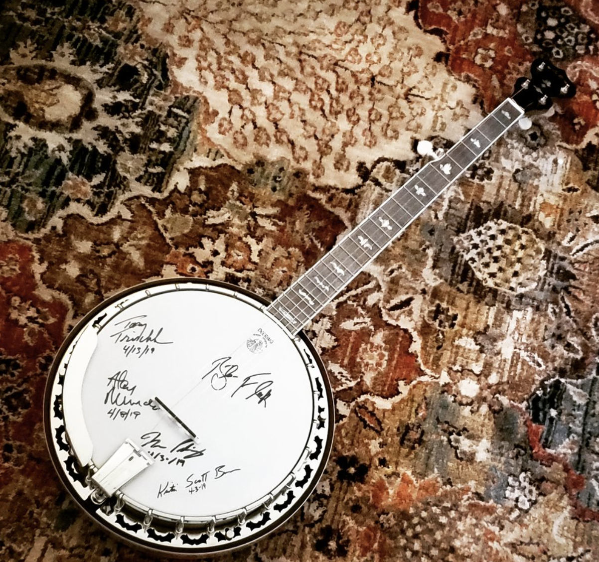 Bid on a signed Deering White Lotus Banjo!