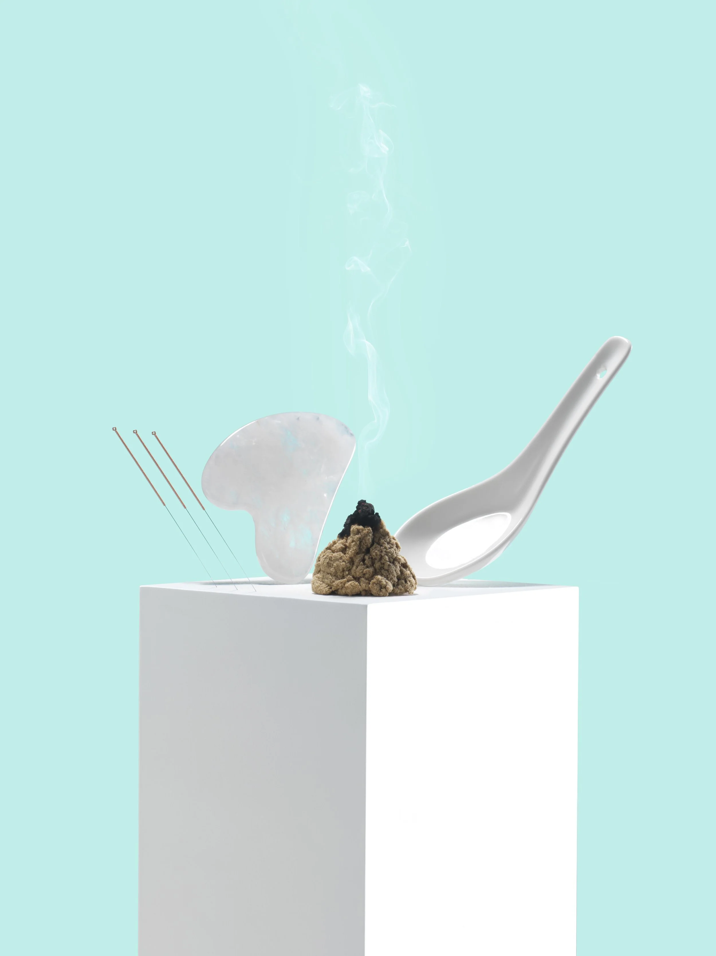 Acupuncture needles and acupuncture ancillary tools on a white box with blue background