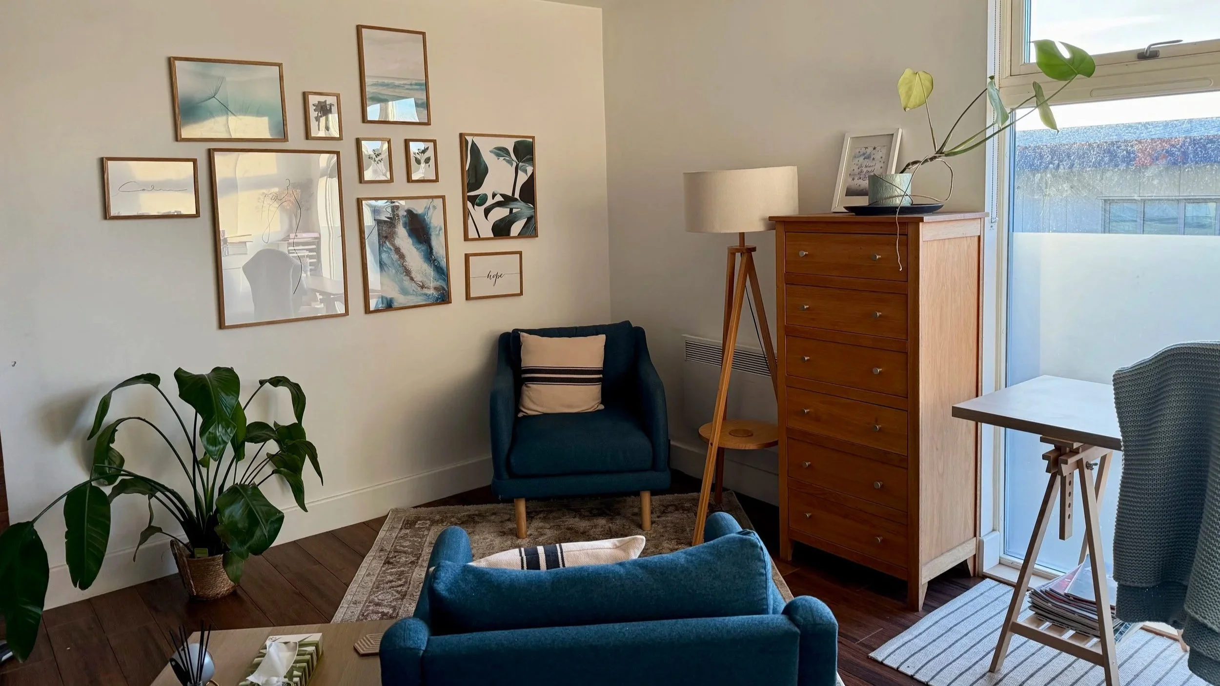 acupuncture consultation space in the Brockley acupuncture clinic, two chairs and a print wall
