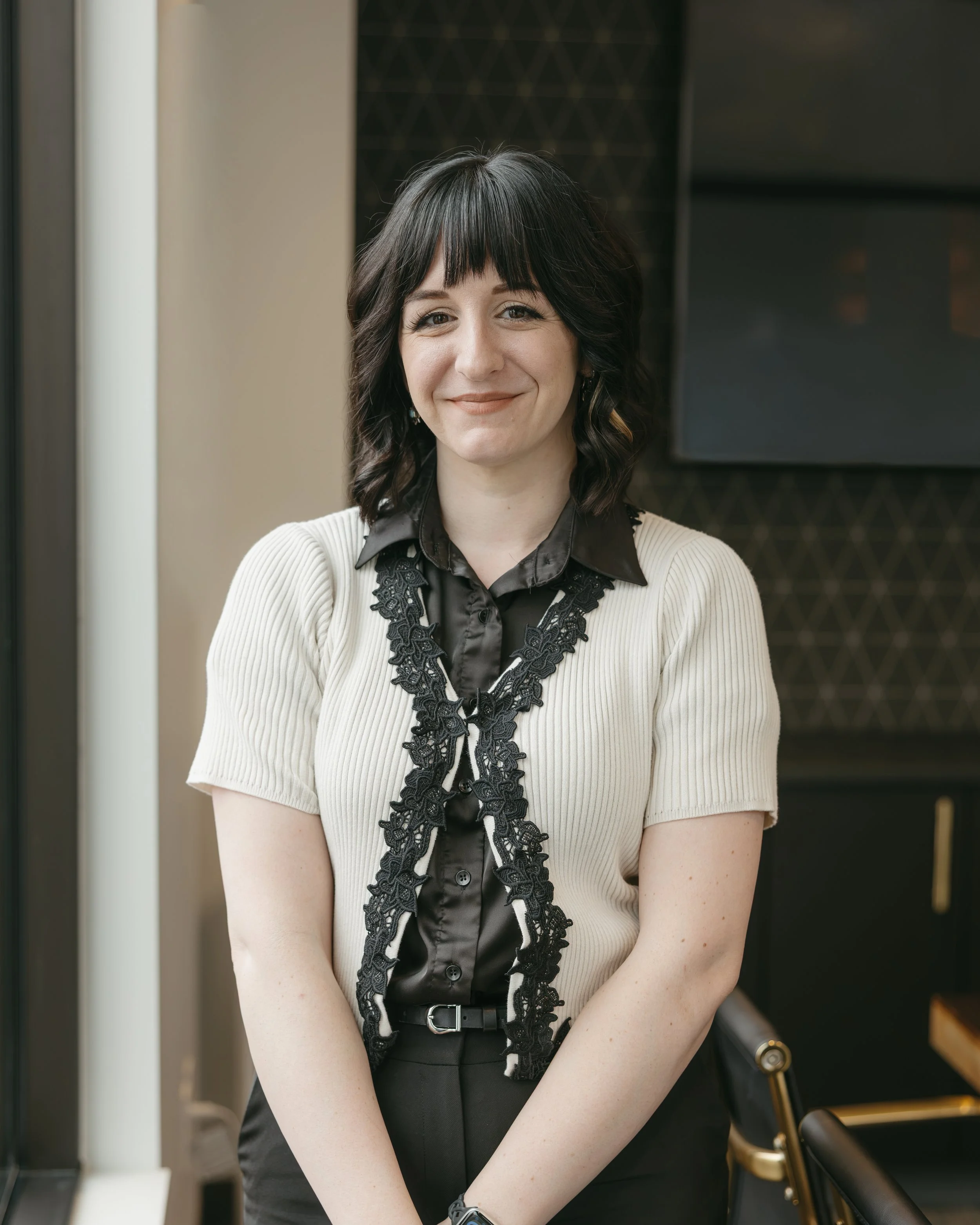 Photo of Lorraine Gibbons standing by a window in a stylish legal office
