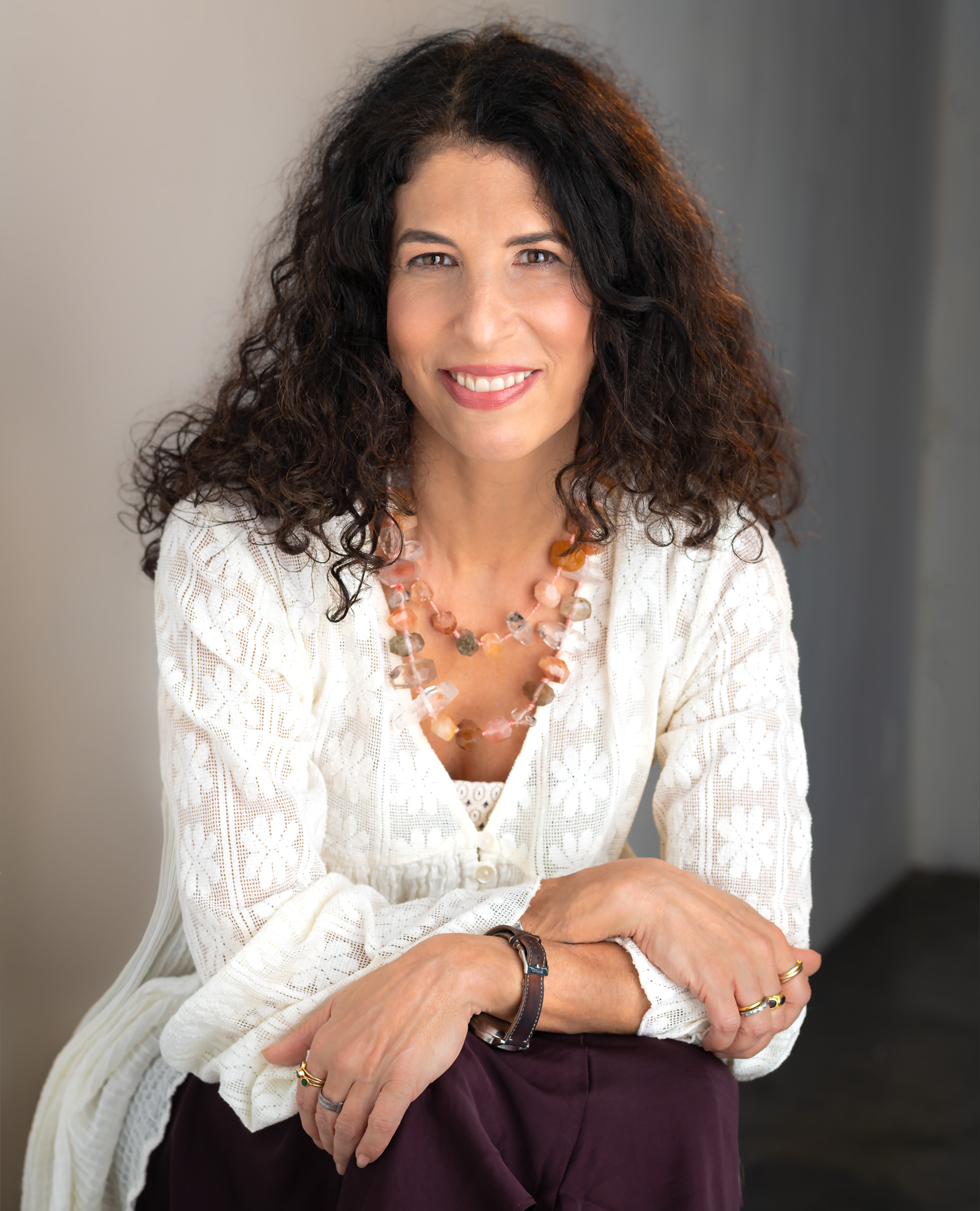 Denise Wiesner, a Natural Fertility Expert, leaning against a chair