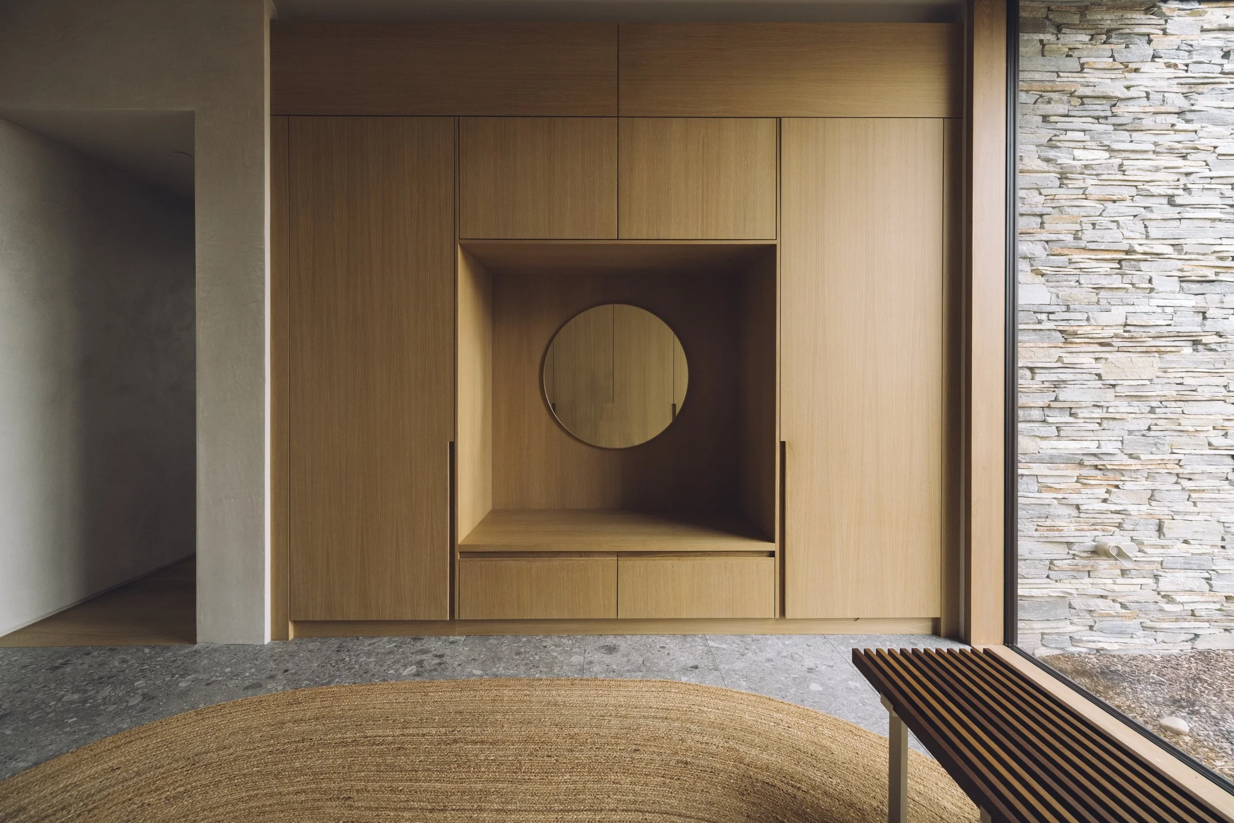 Oak millwork beside a stone wall