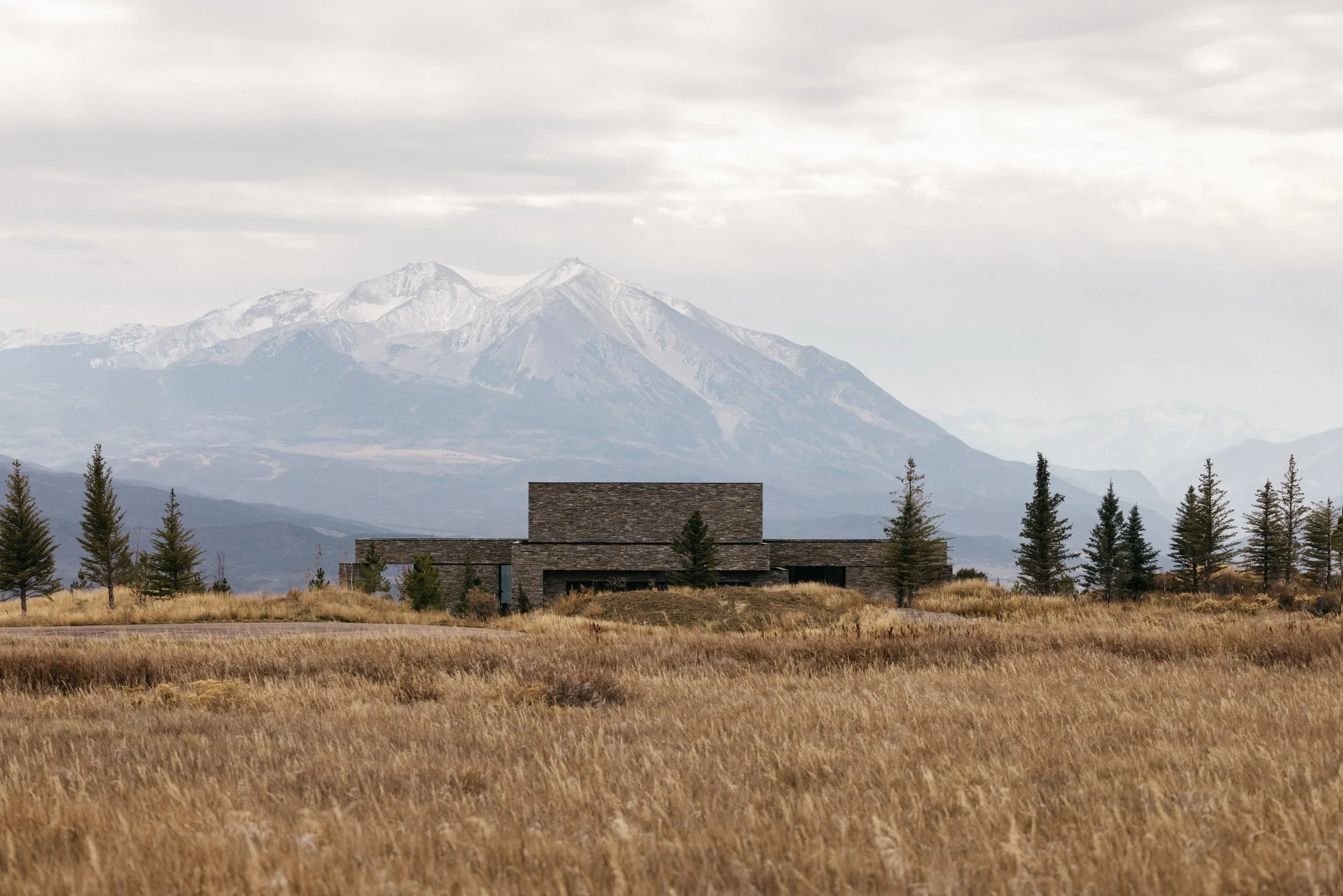 The house low in the meadow beneath Mount Sopris