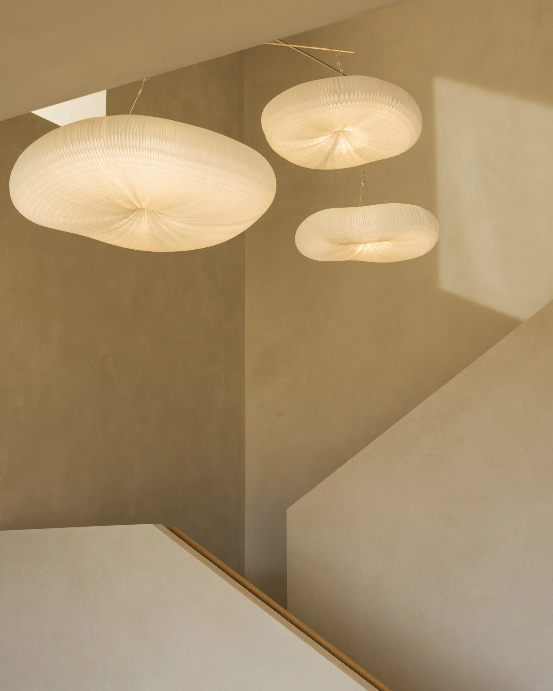 Lime plaster stair hall with paper pendants
