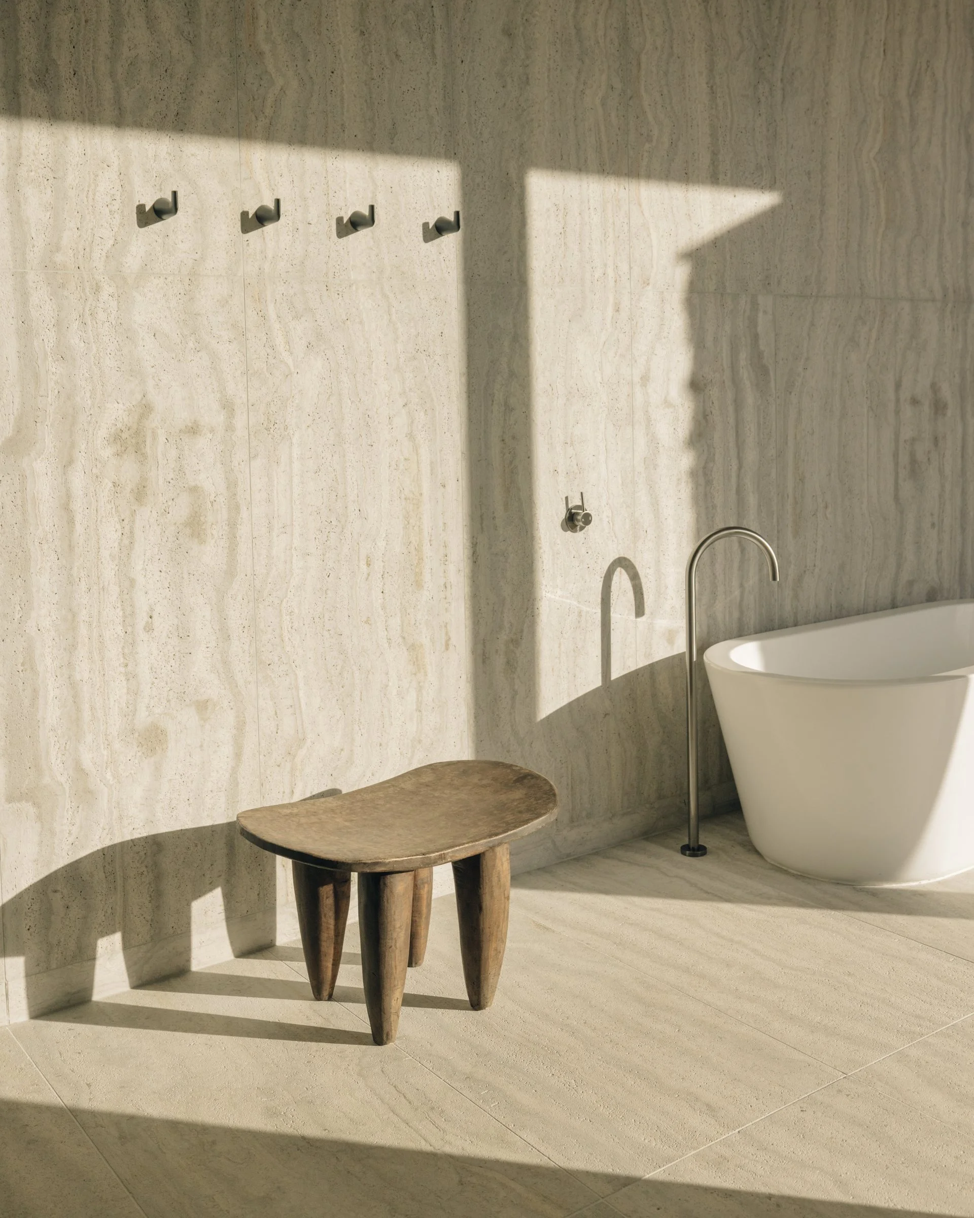 Travertine bath with a freestanding tub