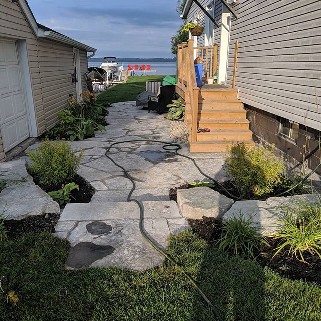 Jumbo flagstone patio/walkway by the lake, with some simple plantings.

Natural stone is an amazing addition to any outdoor space, call us for a free estimate! 905-235-3211

#cutabovenaturalstone
#hardscaping
#southsimcoelandscapeconstruction 
#jumbo