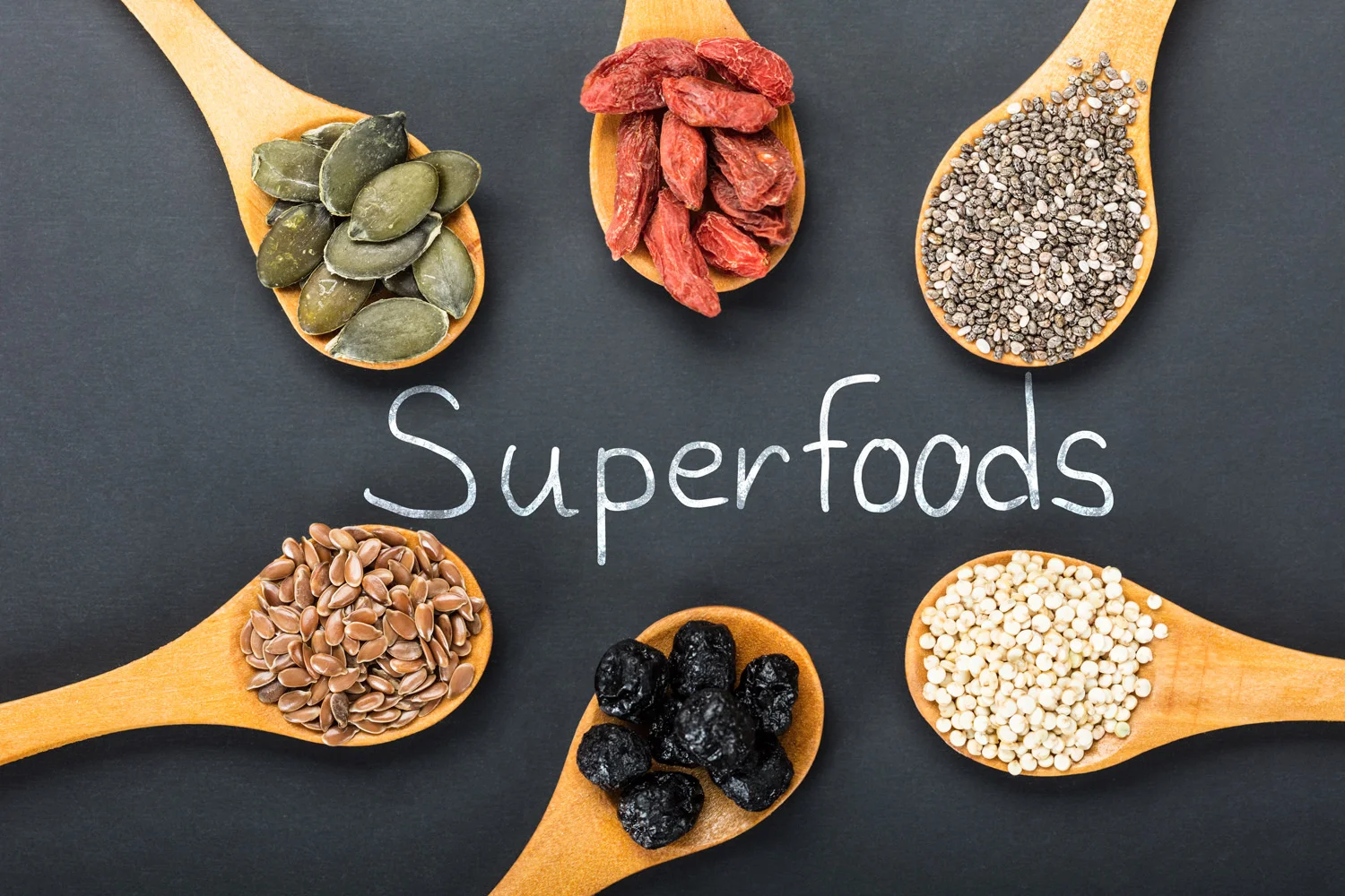 Superfoods-on-spoons-with-a-lettering-black-backround-wooden-spoons.jpg
