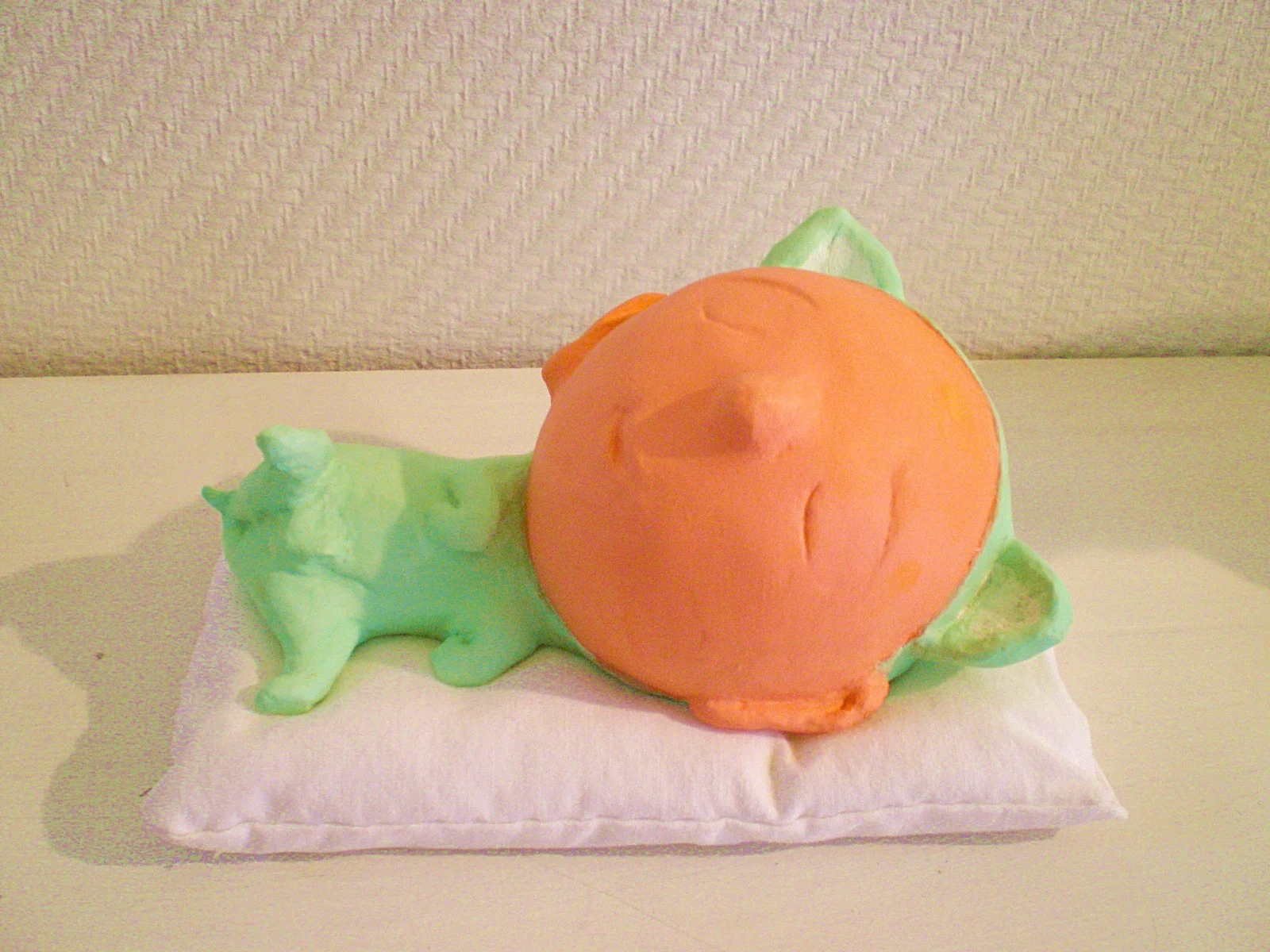 Sleeping baby cat with green cloth 