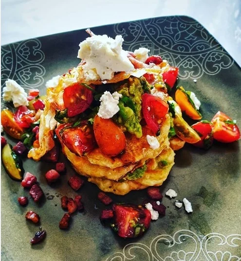 Brunch Corn Fritters, smashed avocado, tomato and balsamic salad, fried prosciutto and feta.