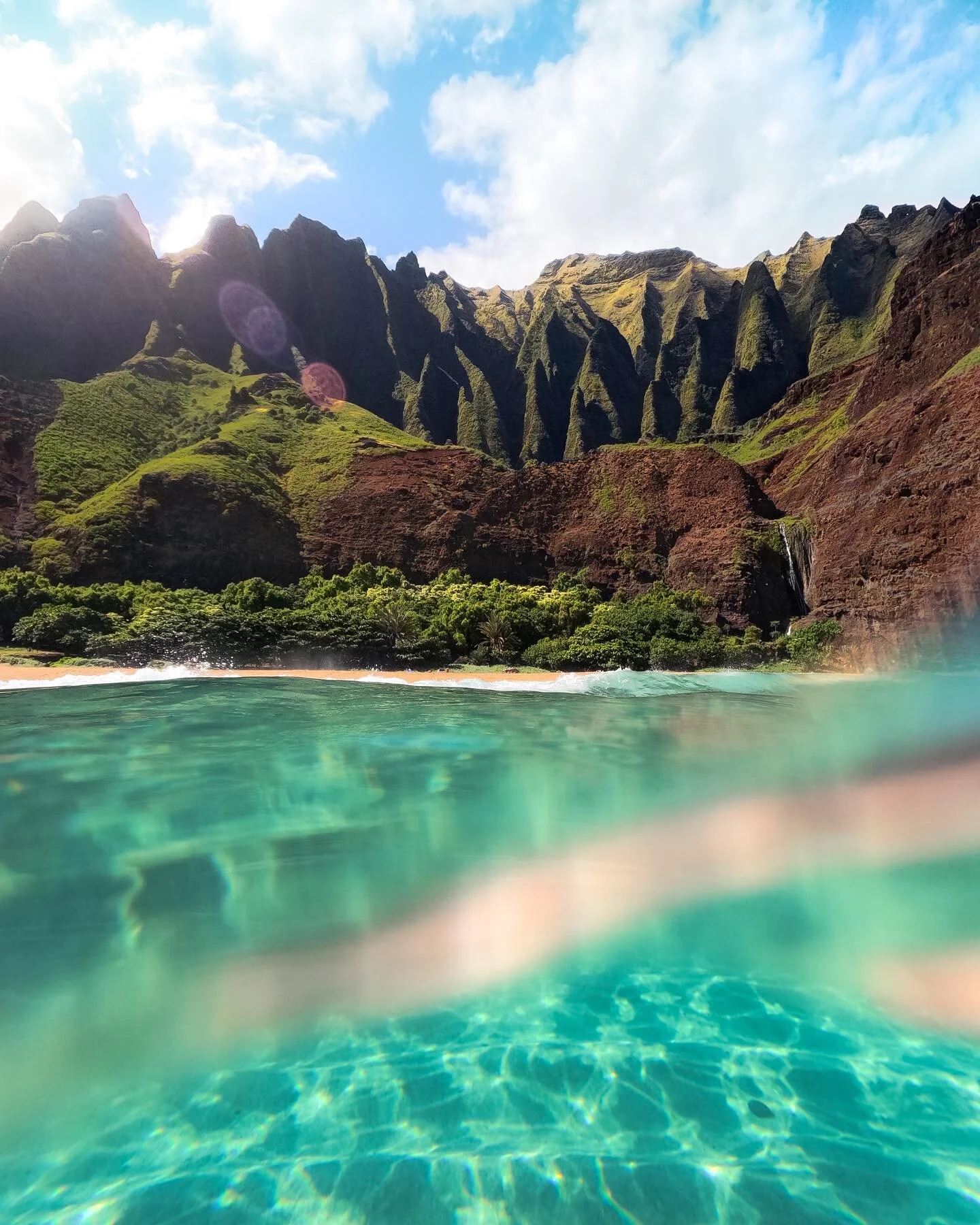 Happy Aloha Friday! Celebrating with one of my favorite photos that I took during our Kalalau trip. 

Being able to float in this crystal clear water beneath the cathedral&rsquo;s on an empty beach was one of the coolest moments I&rsquo;ve had here i