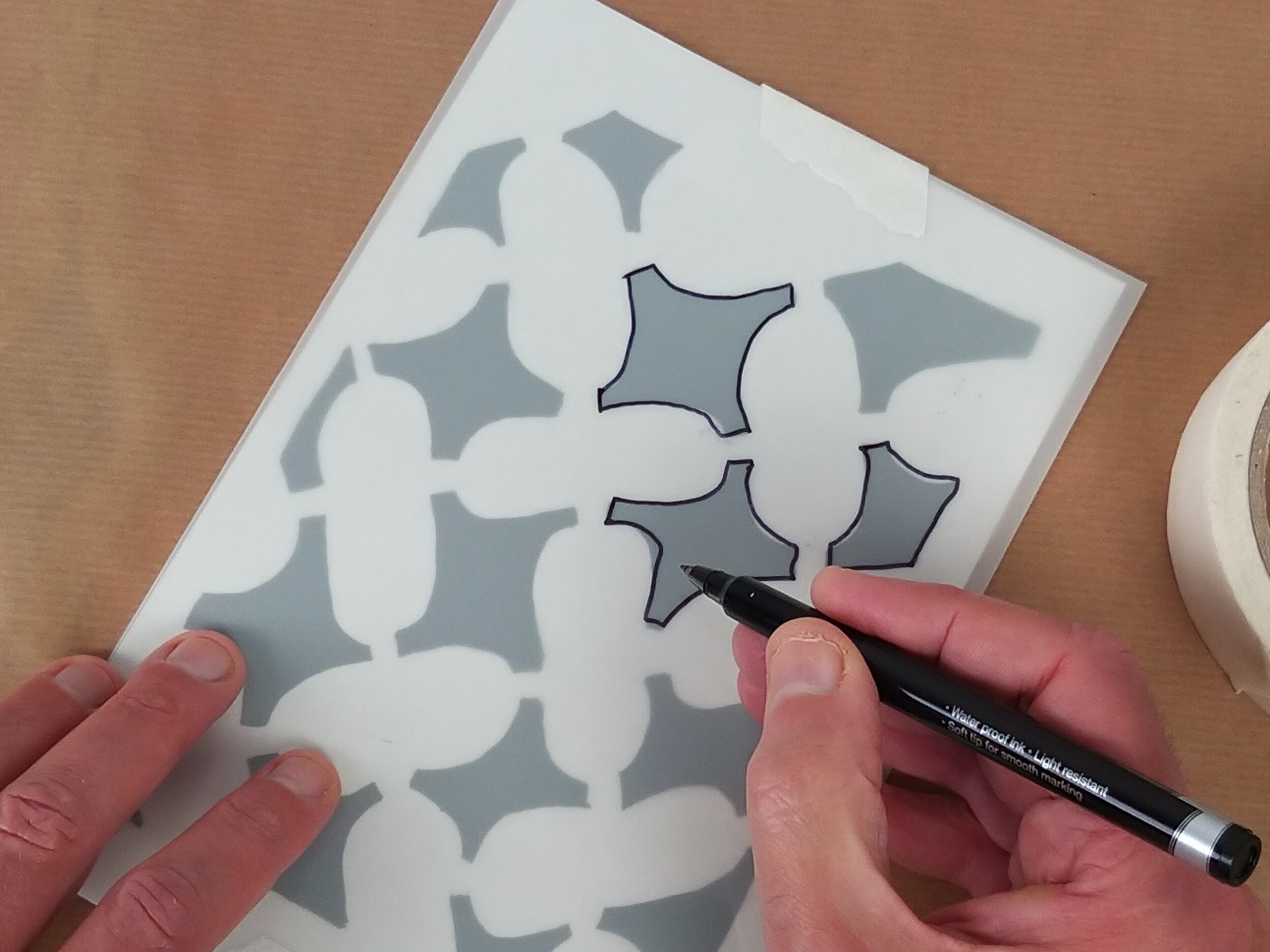  Using the marker pen begin to trace the design onto the stencil sheet. 