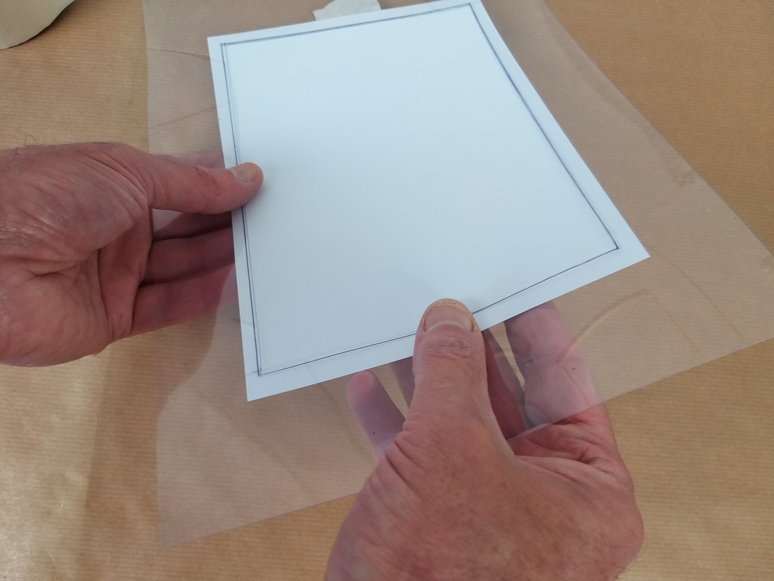  The transparent frame makes it easy to line up the edges of the paper making an accurate border. 