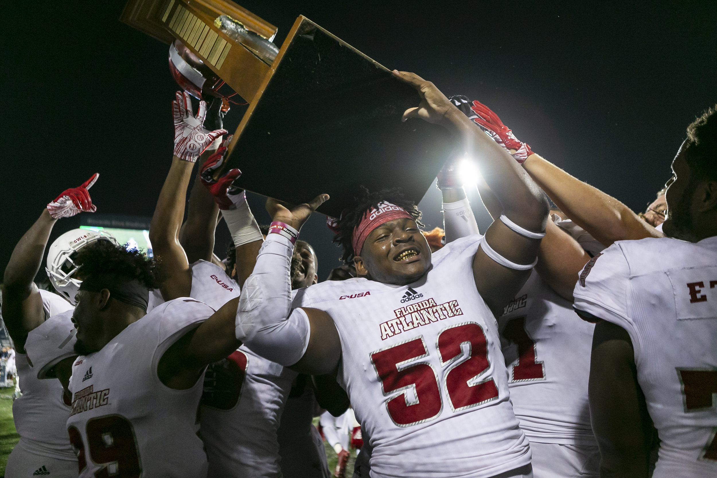  FAU defensive end Jaylen Joyner (52) holds the Shula Bowl XVII trophy after they defeated Florida International University 49 to 14 at the Riccardo Silva Stadium in Miami on Saturday, November 3, 2018. 