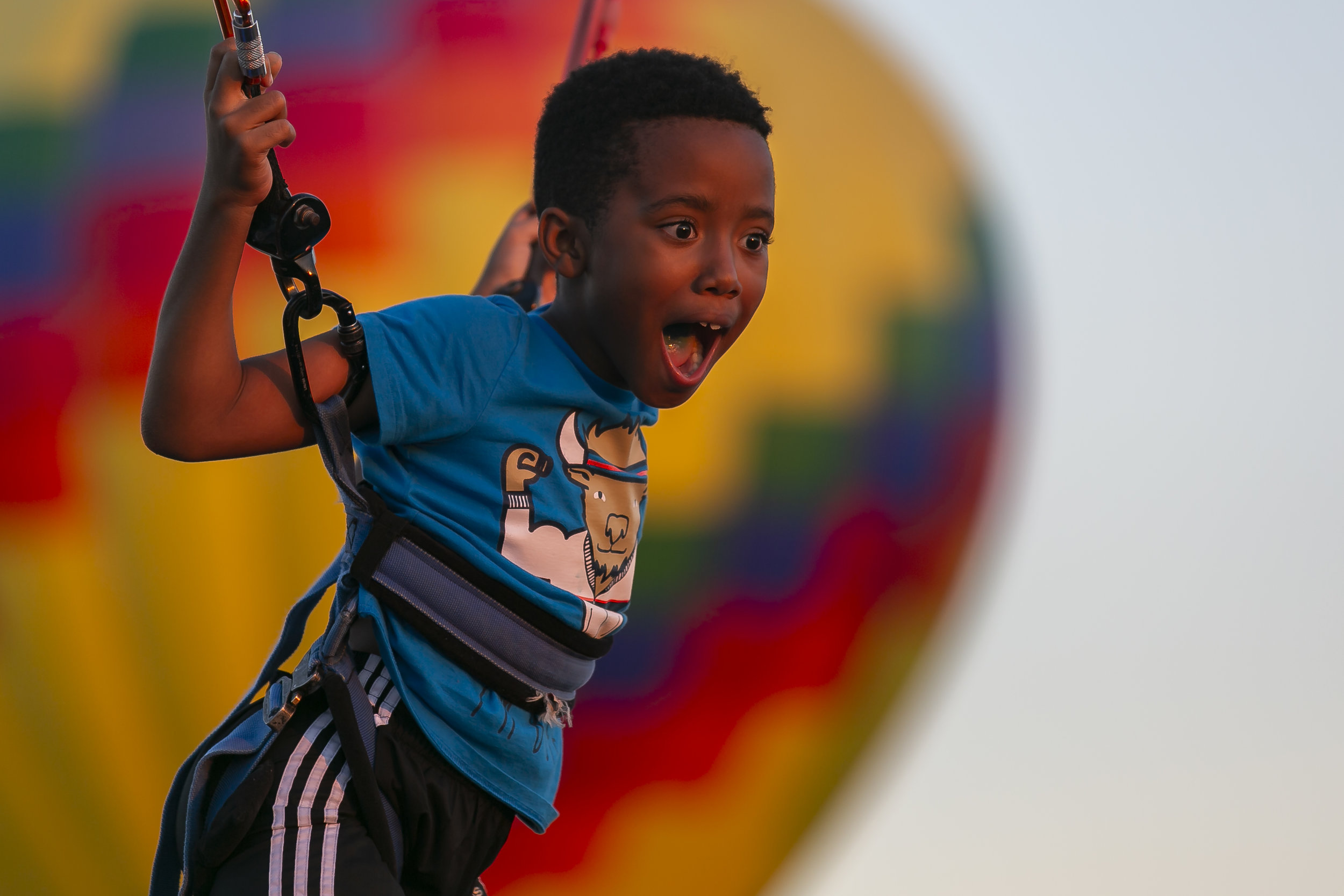  Dax, 9, reacts while riding a bungee trampoline during the Homestead Miami Balloon Glow on March 2, 2019, near the Homestead-Miami Speedway in Homestead, Florida. 