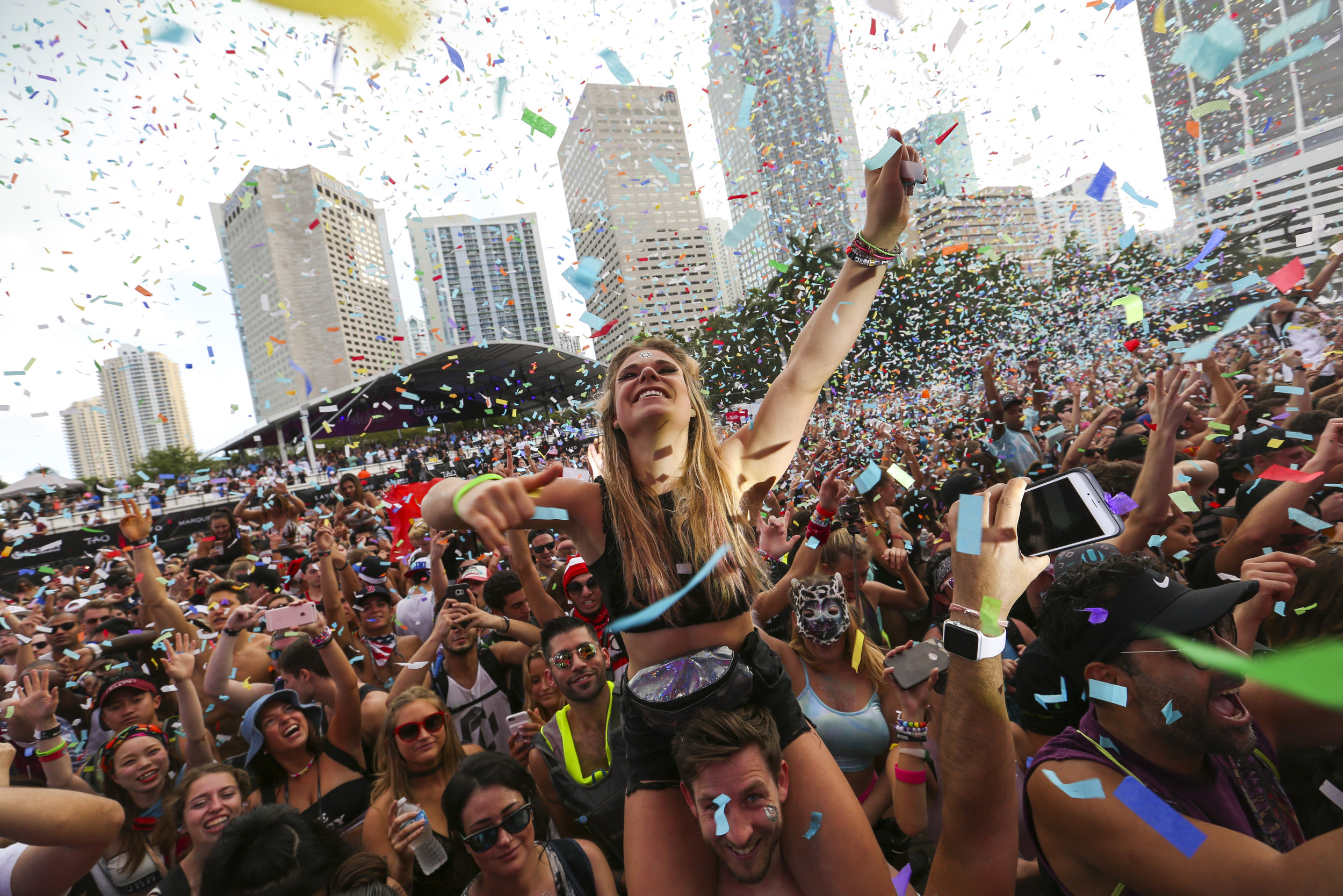  Alina Baum, 24, from Germany, dances as confetti sprinkles the crowd during the third day of Ultra Music Festival in downtown Miami on Sunday, March 26, 2017. 