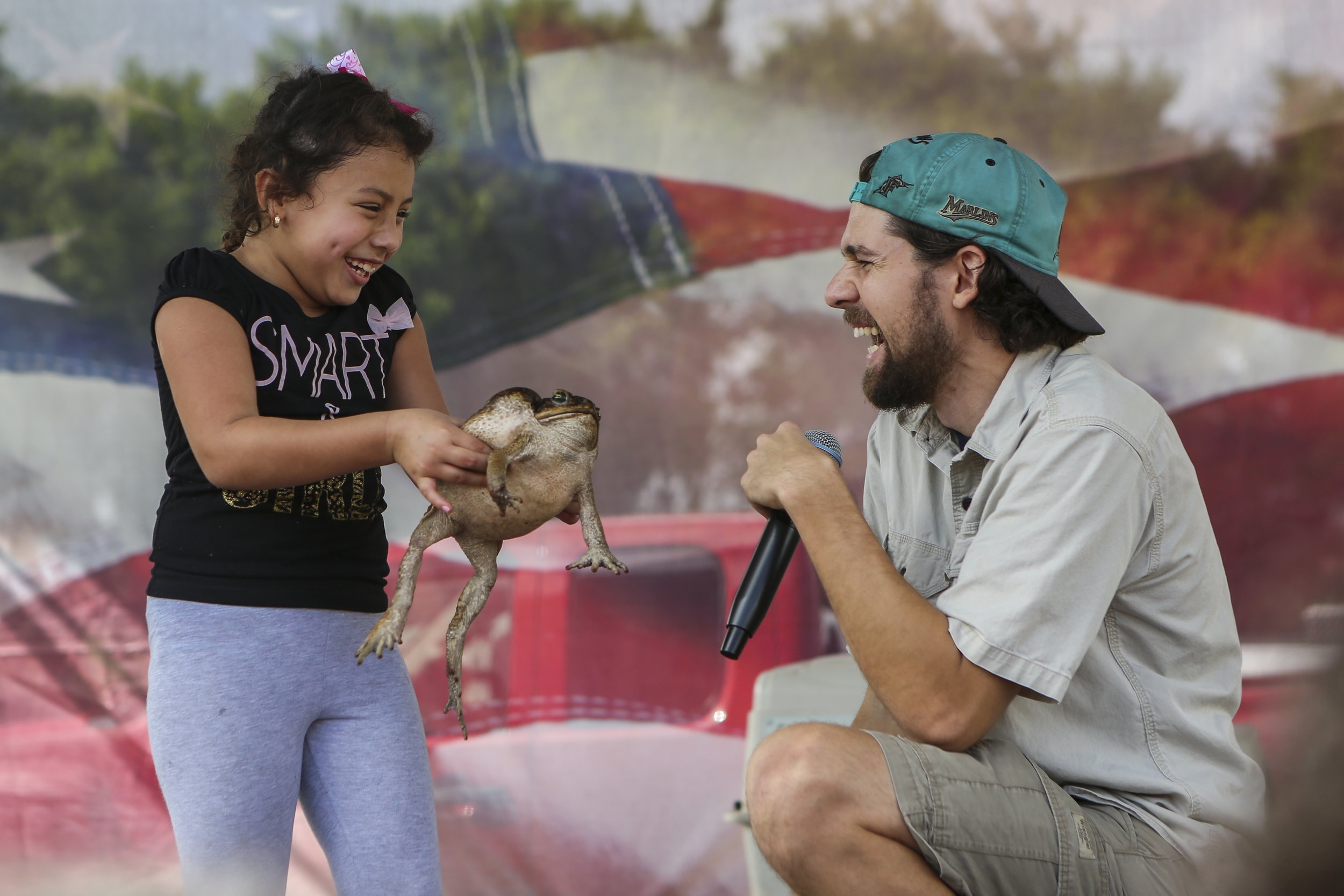  Ashley Castillo, 6, and Raul Tamayo, 24, react while Castillo holds a cane toad during the 29th annual Dodge City Christmas Party in Richmond West on Sunday, December 18, 2016. More than a 1,000 underprivileged kids throughout South Florida were exp