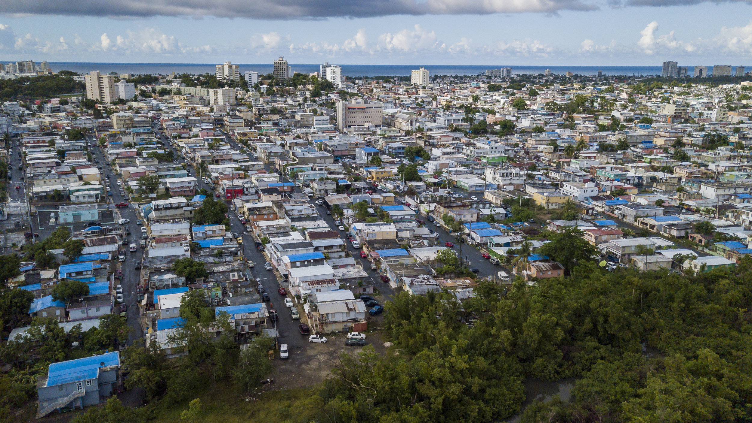  Many homes in the Caño Martin Peña communities in San Juan, Puerto Rico still lack permanent roofs on August 24, 2018 a year after Hurricane Maria. 