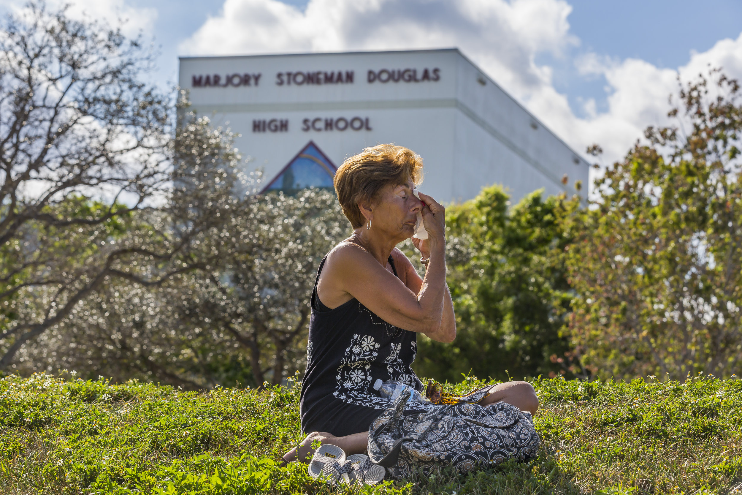  Diane Cappelli wipes tears as she mourns in front of Marjory Stoneman Douglas High School in Parkland, Florida on Sunday, February 18, 2018. A gunman entered the school and killed 14 students and 3 teachers. 