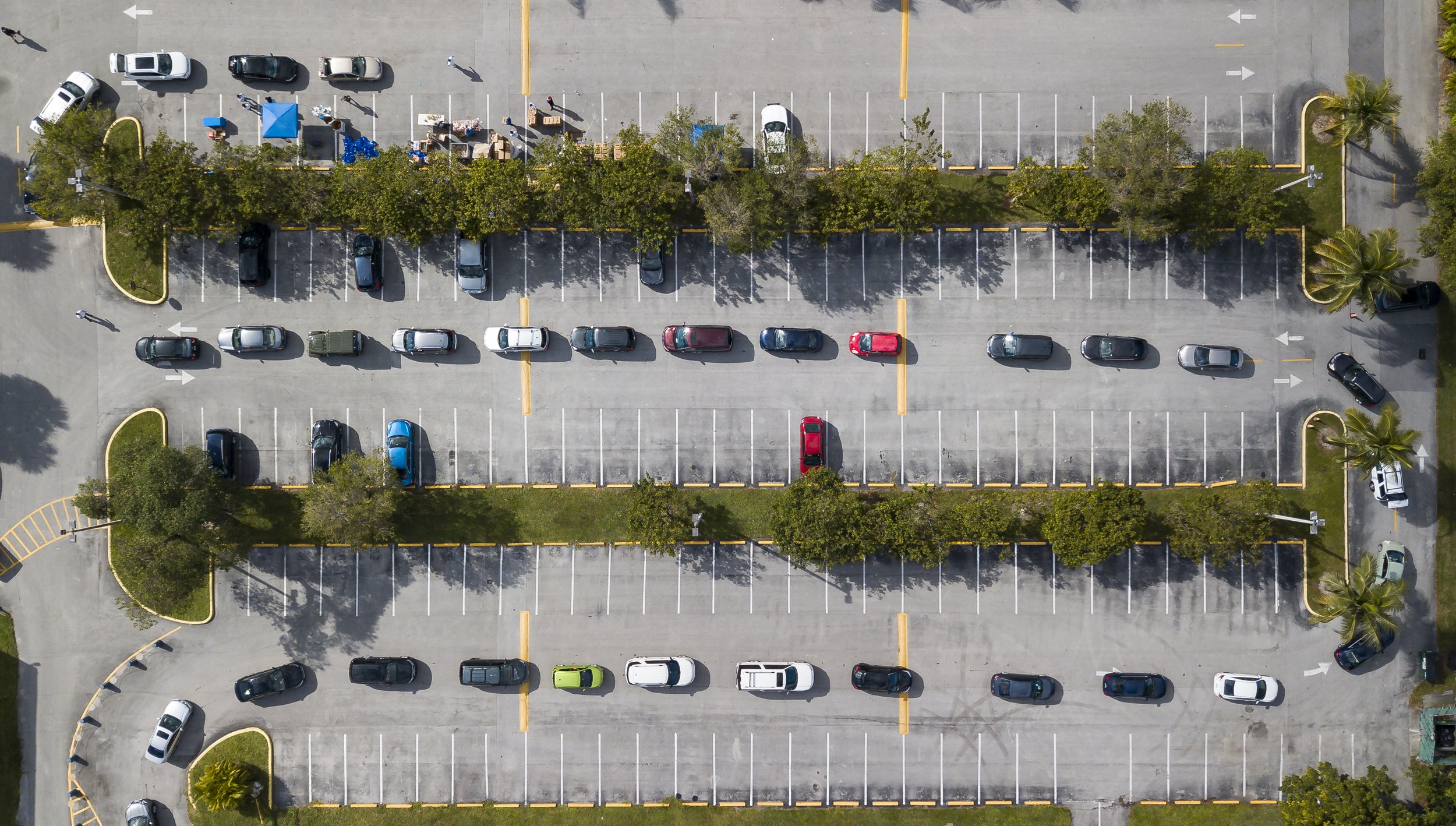  An aerial view shows cars lining up to receive food during a drive-thru event where members of the Nicaraguan community celebrated the religious event La Griteria at the St. Agatha Catholic Church in Miami, Florida on Saturday, December 19, 2020. La