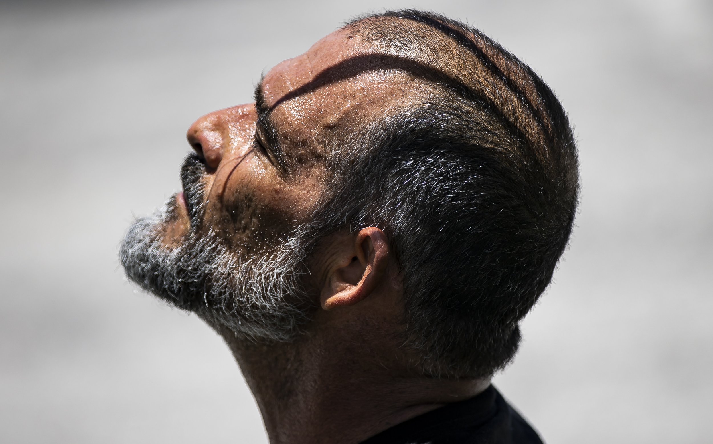  Beads of sweat gather on Orlando Castro, 53, as he takes a moment to rest after riding his bike at Haulover Skateboard Park on Wednesday, June 14, 2023, in Miami Beach, Fla. Miami-Dade County issued a heat advisory for residents after the National W