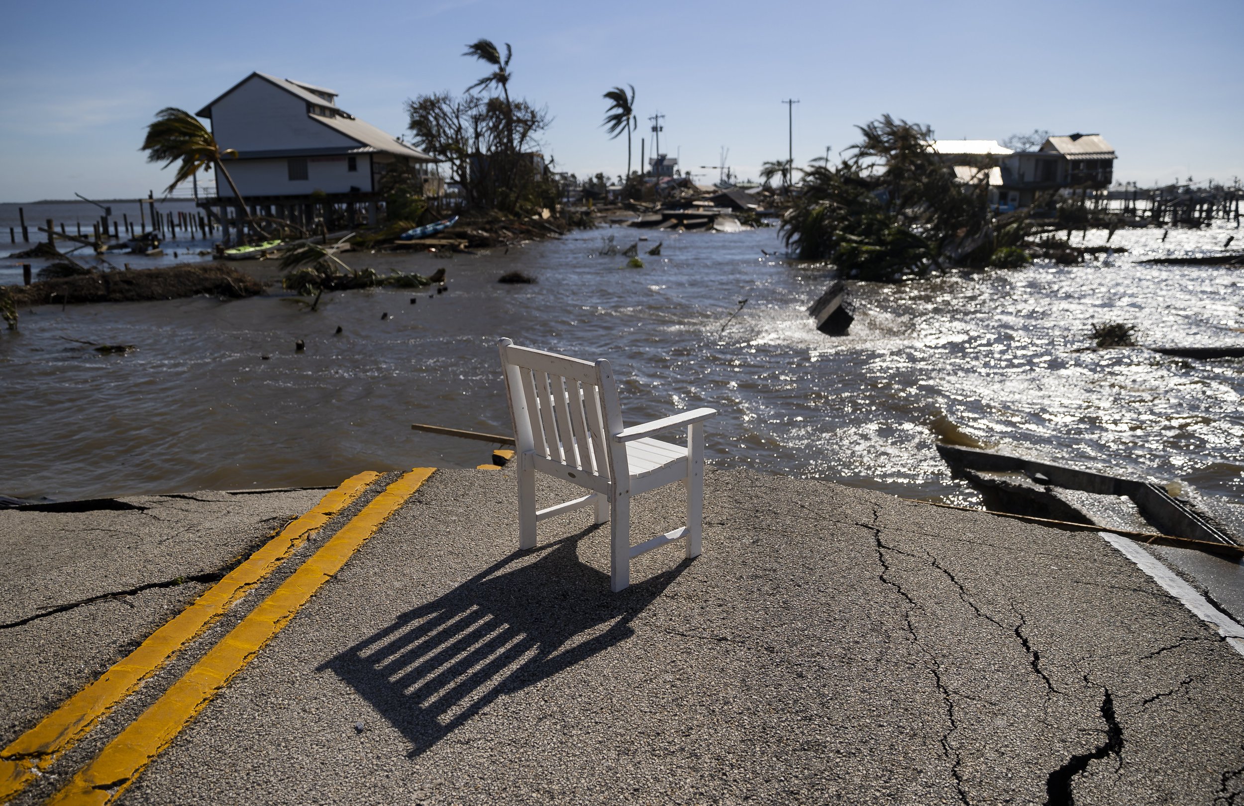  Gulf water flows through a broken section of Pine Island Road on Thursday, Sept. 29, 2022, in Matlacha, Fla. Hurricane Ian made landfall on the coast of South West Florida as a category 4 storm Wednesday afternoon leaving areas affected with flooded