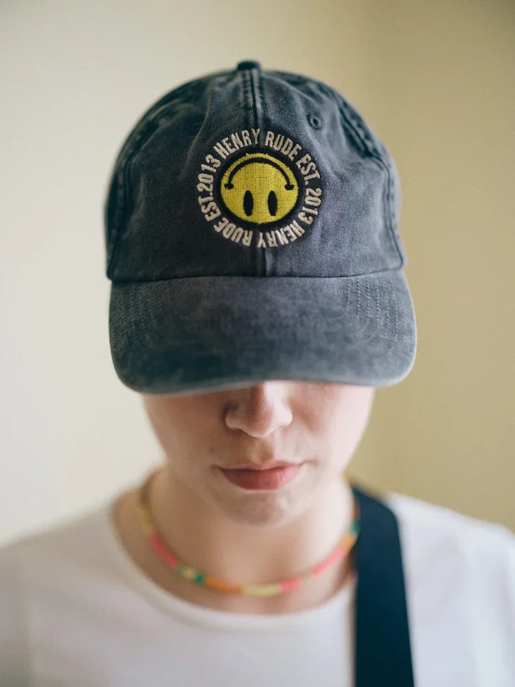black cap with smiley logo