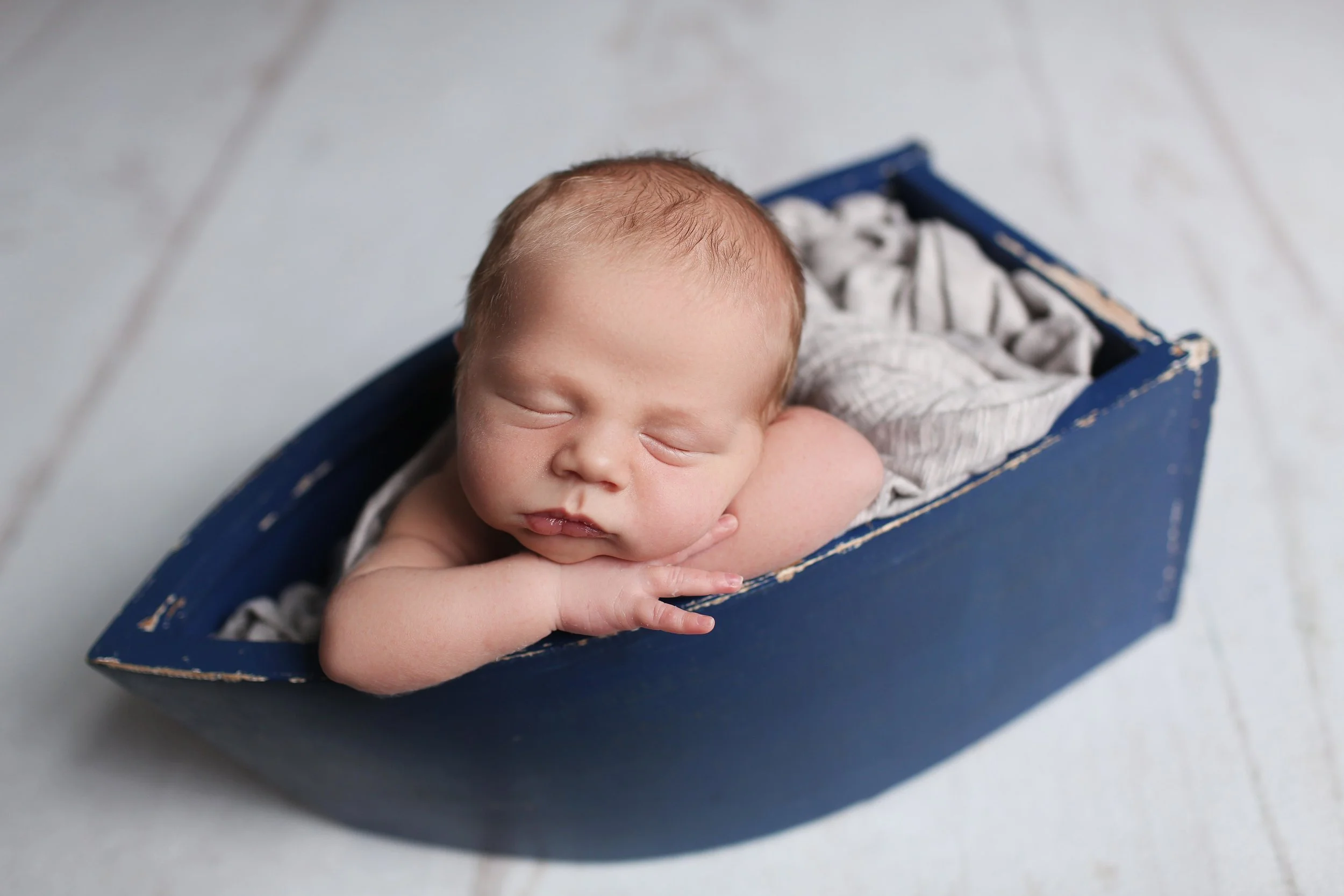 Truly You Photography Oklahoma Newborn boy sleeping in blue boat