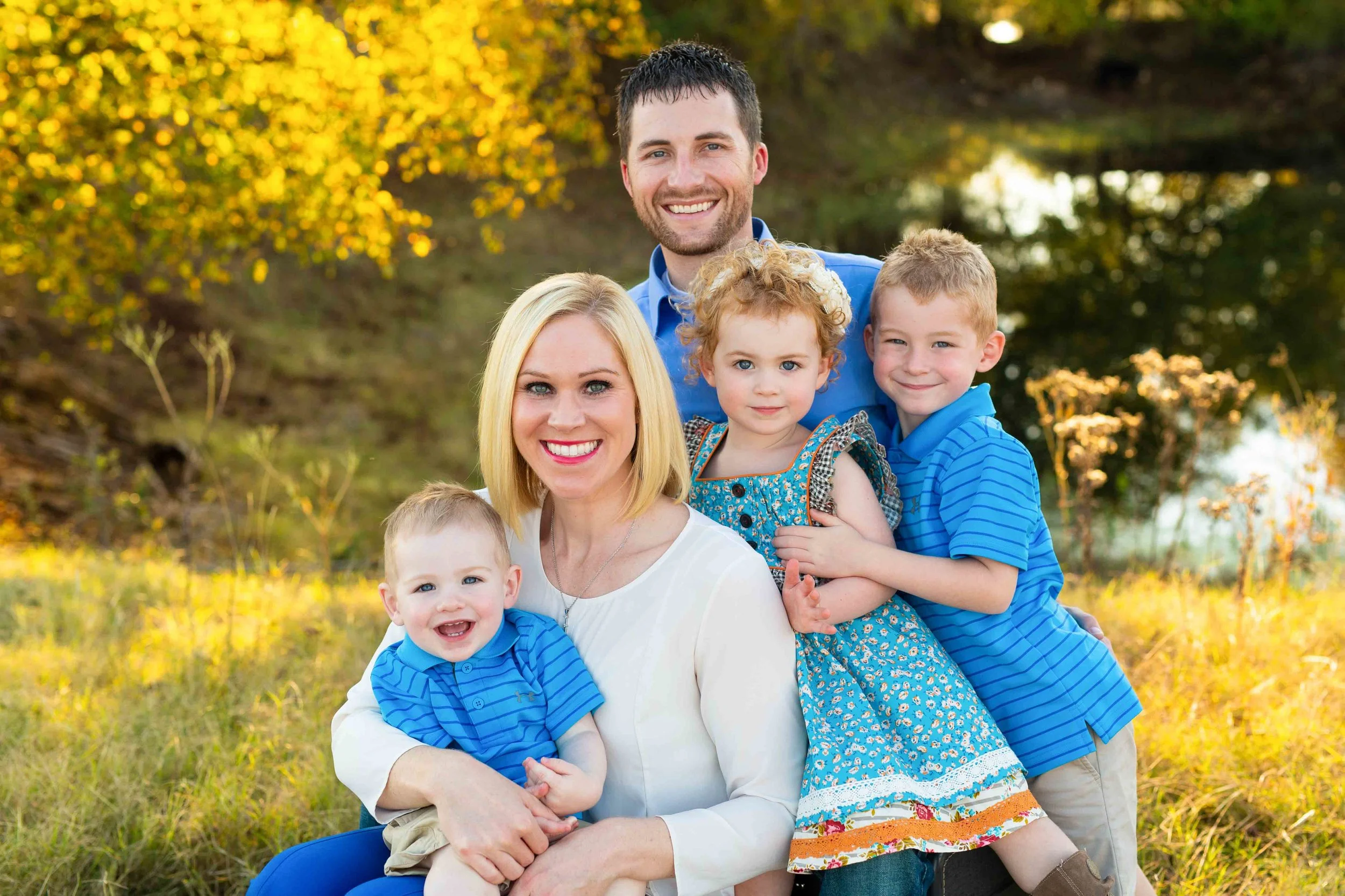 Truly You Photography Oklahoma family together in front of pond with three kids