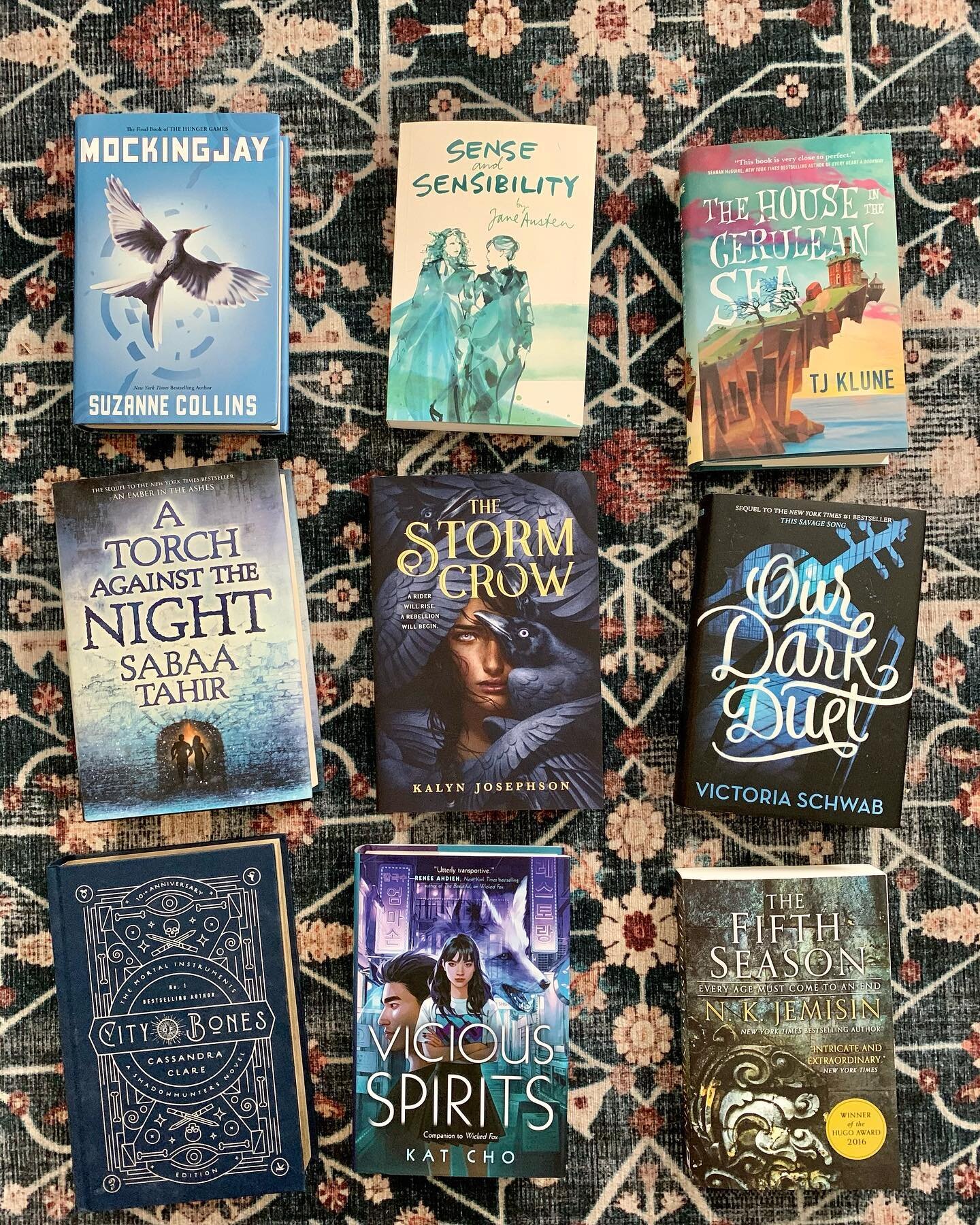 Blue (or blue-ish) books! The new blue rug decided my theme for today. It seems as legitimate as any grouping. 

Swipe for my adorable sleepy companions. One of which is a certified book murderer so this was a dangerous proposition. 

#mockingjay # s
