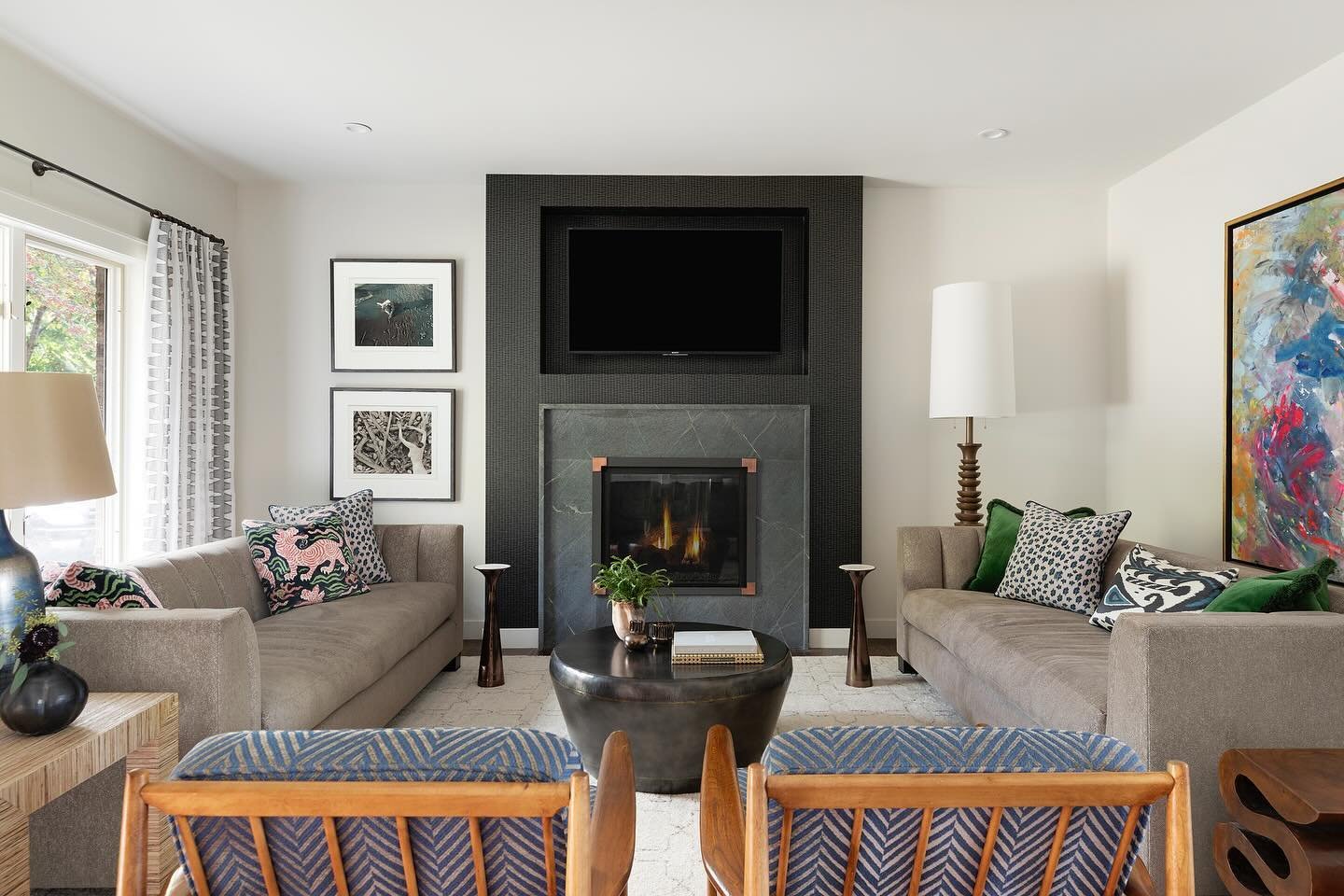 The age-old TV and fireplace problem solved with a custom niche, black wallpaper, and a bracket that allows the TV to pull down. No more creaky necks! 

Photo: @spacecrafting_photography

#heatherpetersondesign #masterthemix #interiordesign #minneapo