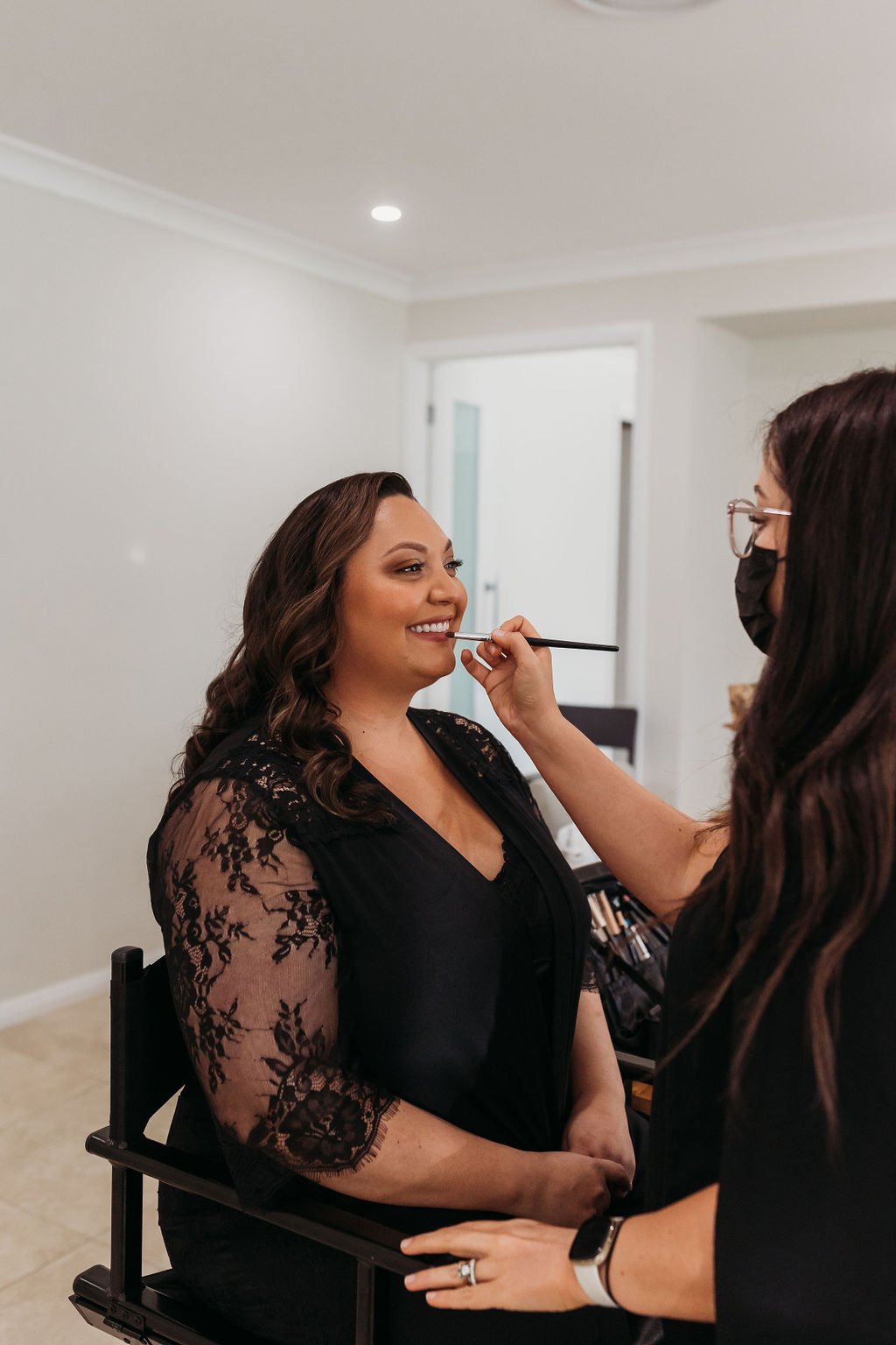 Bride having her makeup applied in a bright bedroom at Dido’s Place in East Kurrajong, preparing for her Hawkesbury wedding day