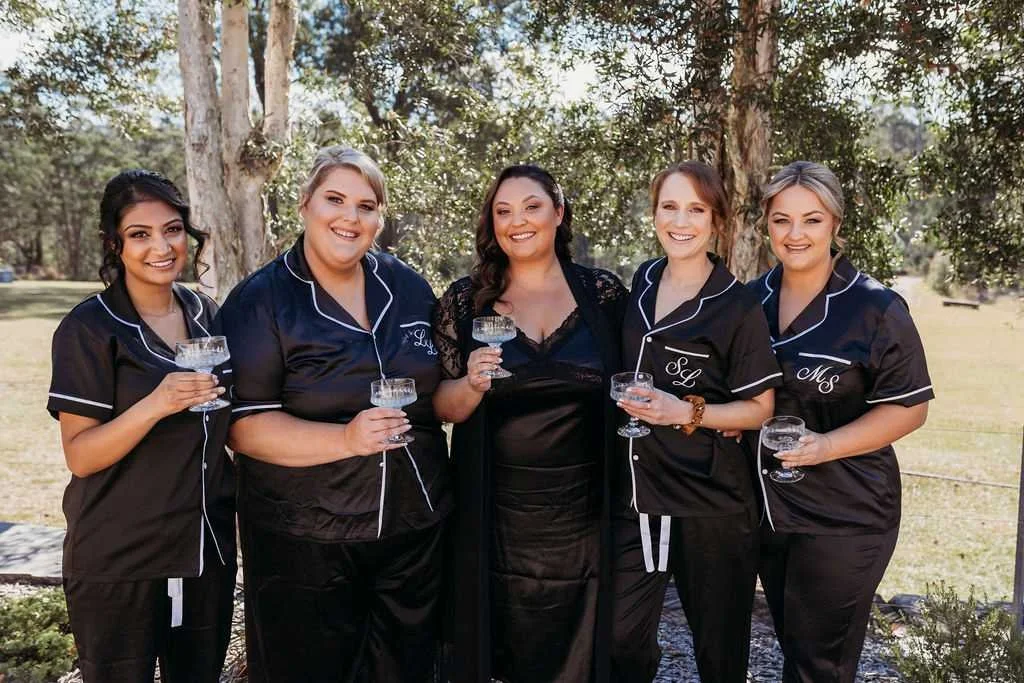 Bride and bridesmaids celebrating together during wedding morning preparations at Dido's Place Hawkesbury wedding accommodation.