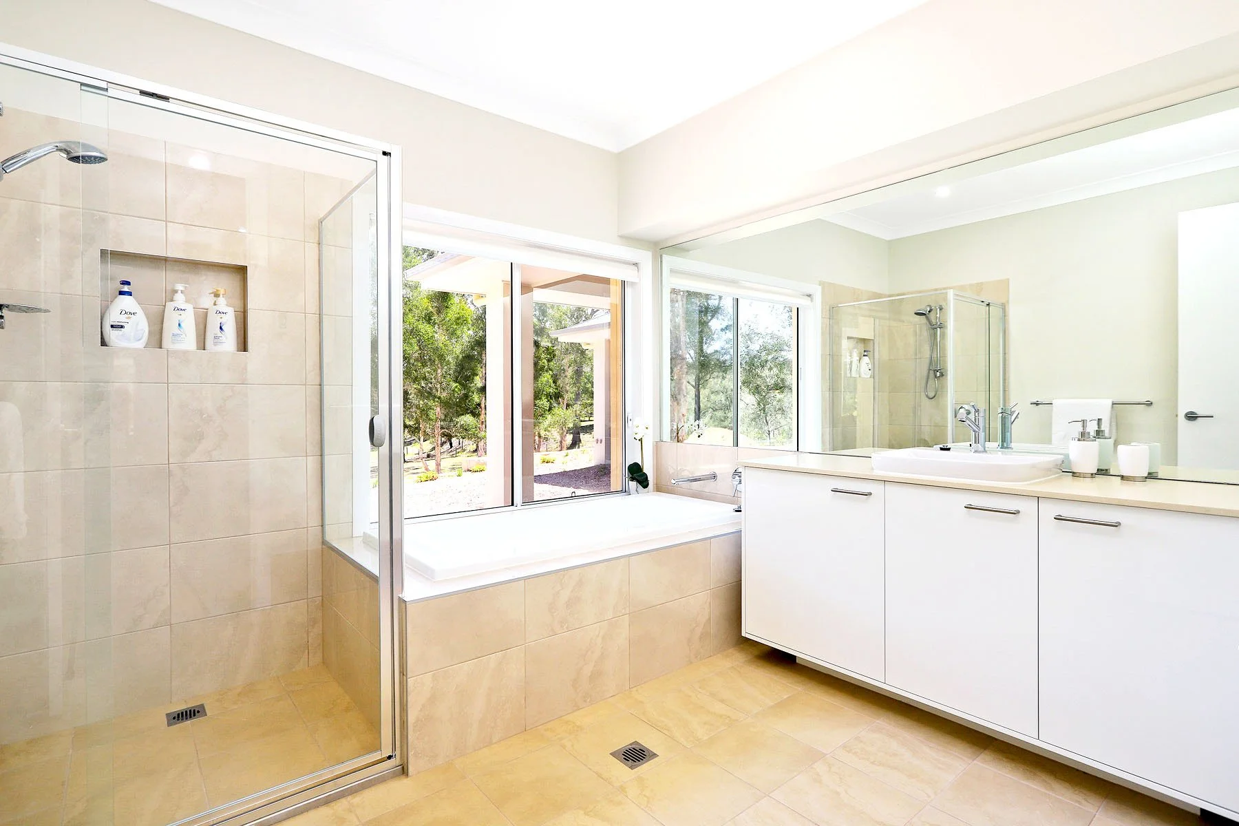 Luxury ensuite bathroom at Dido's Place Hawkesbury accommodation featuring a walk-in shower, deep soaking bath and twin vanity.