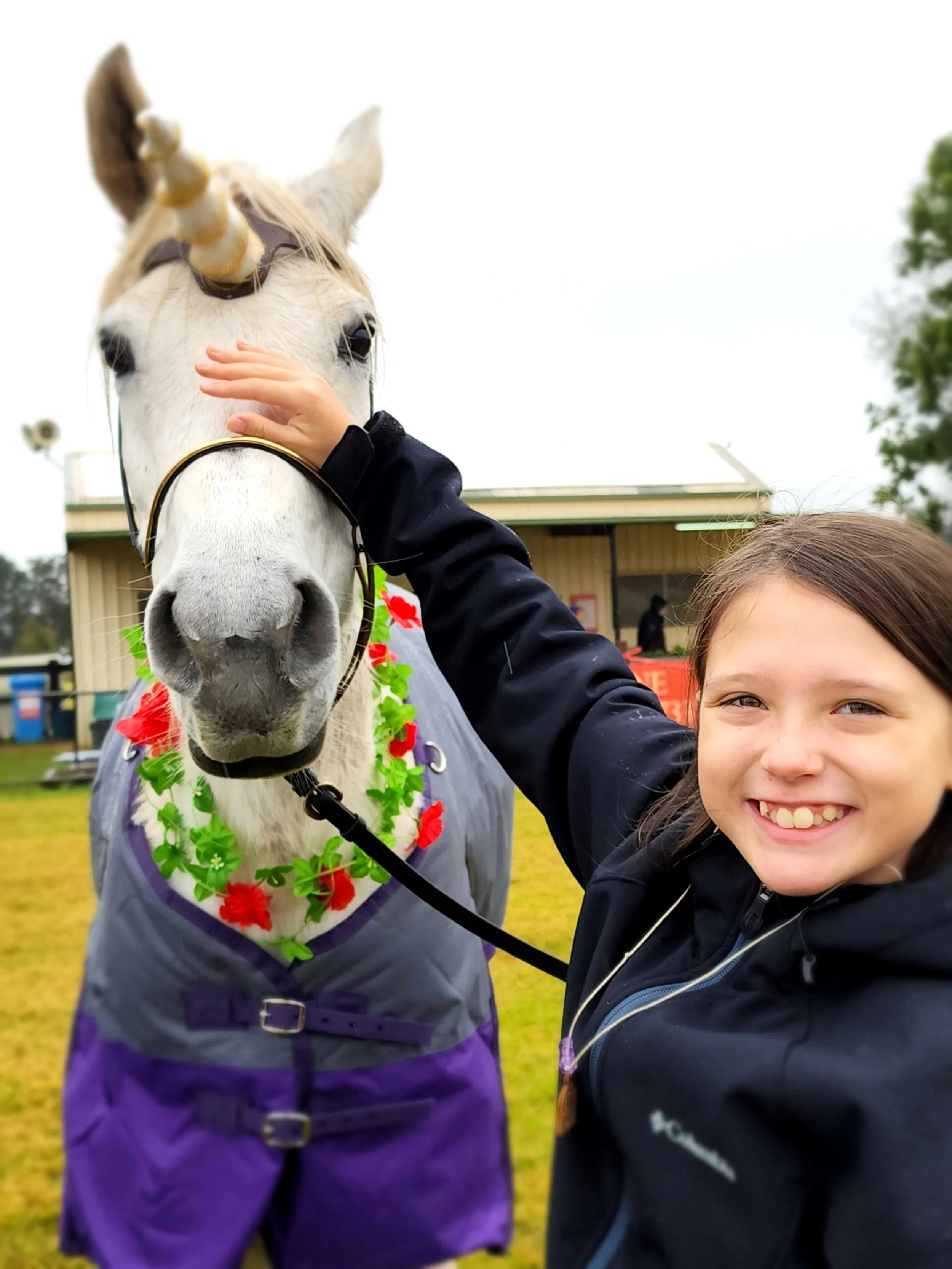 Child meeting a unicorn at Winterfest medieval festival in the Hawkesbury NSW