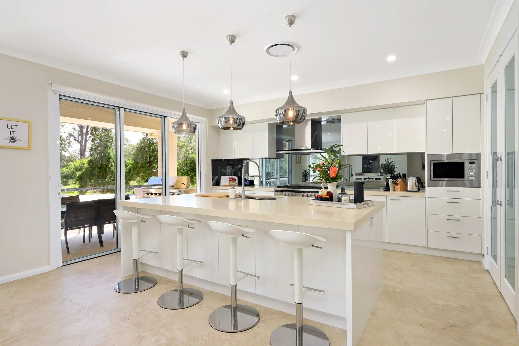 Fully equipped gourmet kitchen at Dido's Place Hawkesbury accommodation with large island bench, breakfast seating and modern appliances.