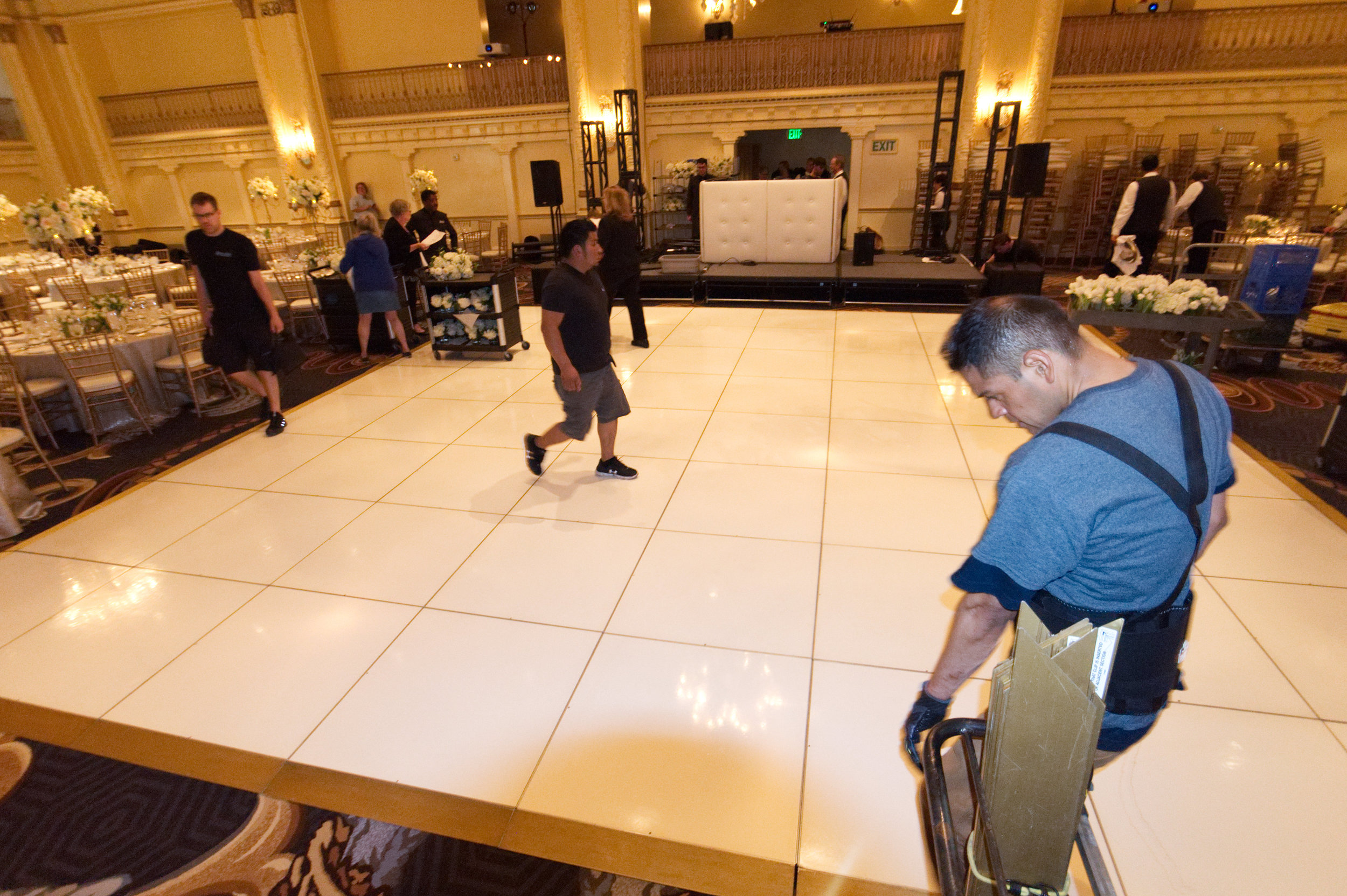  The crew setting up a white dance floor for a bat mitzvah in the Spanish Ballroom at the  Fairmont Olympic Hotel . 