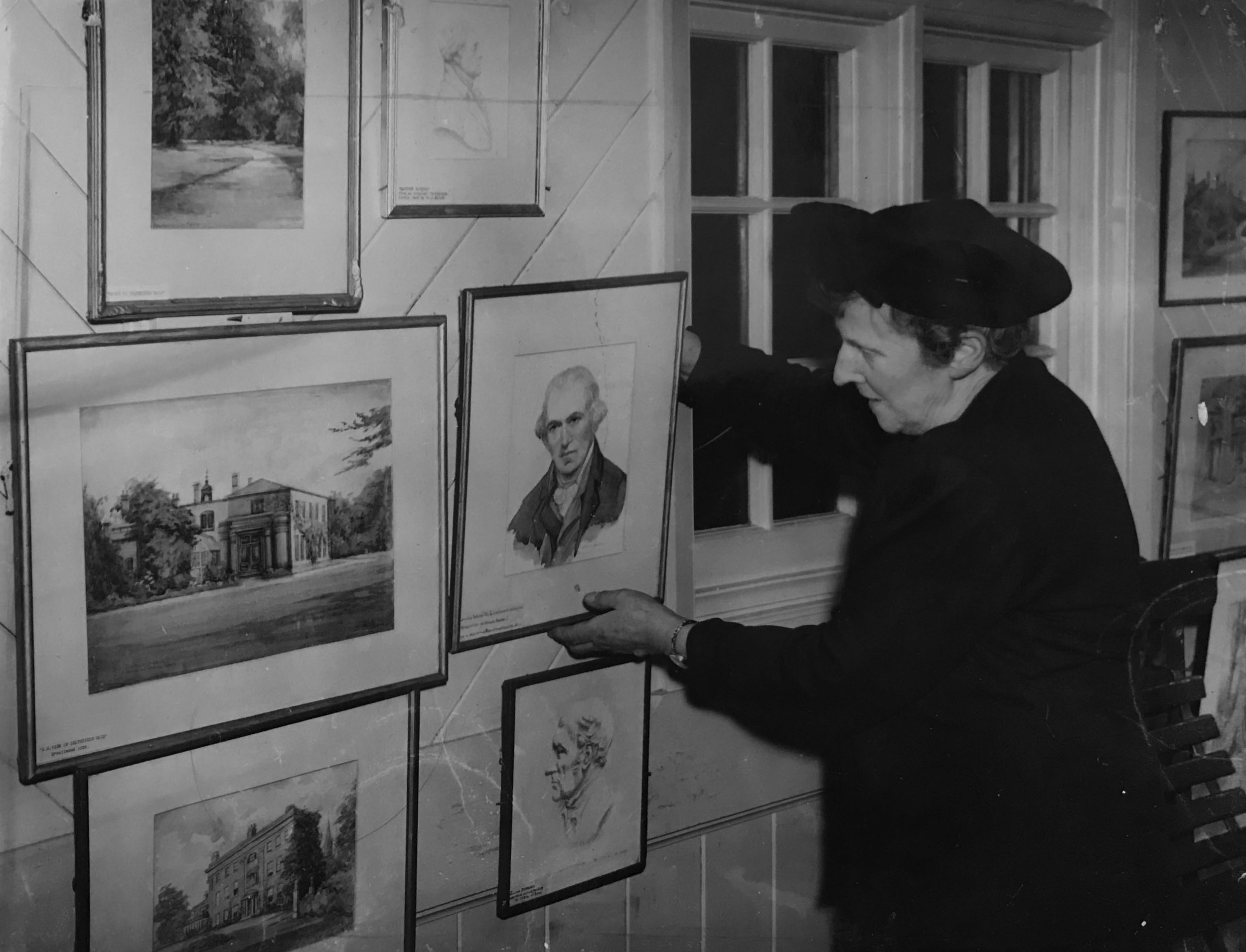 BEATRICE BULLOCK HANGING PICTURES IN THE SONS OF REST BUILDING