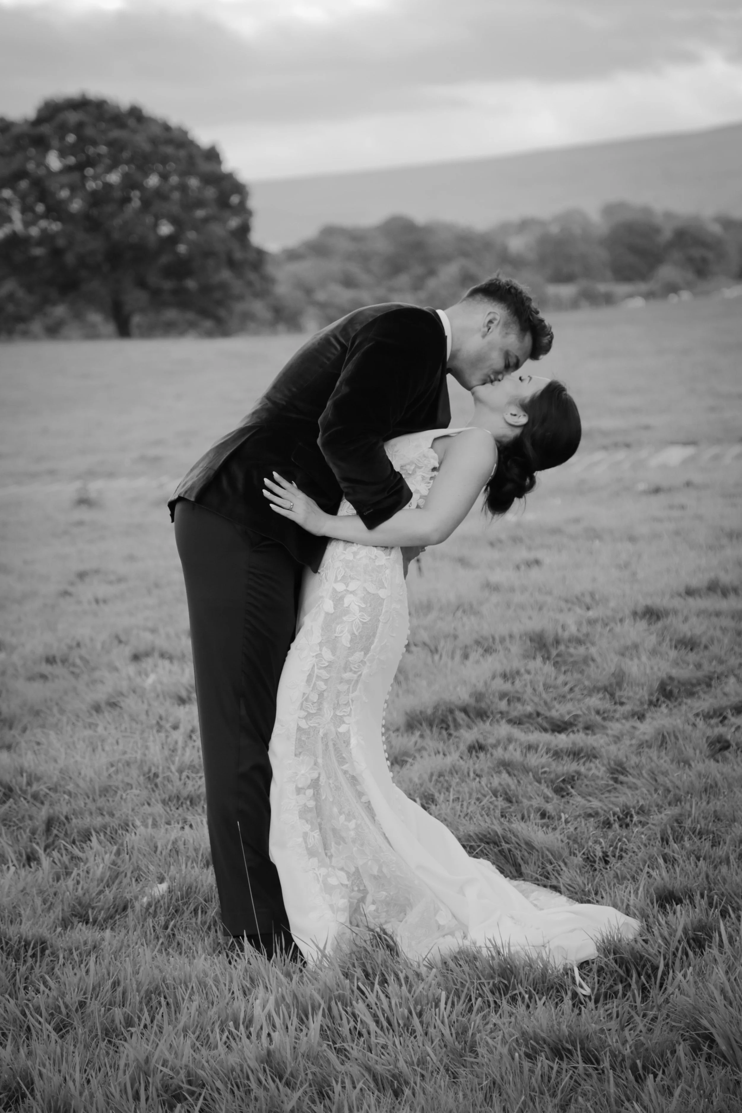 Bride and groom kissing portrait at Tithe Barn, Bolton Abbey.