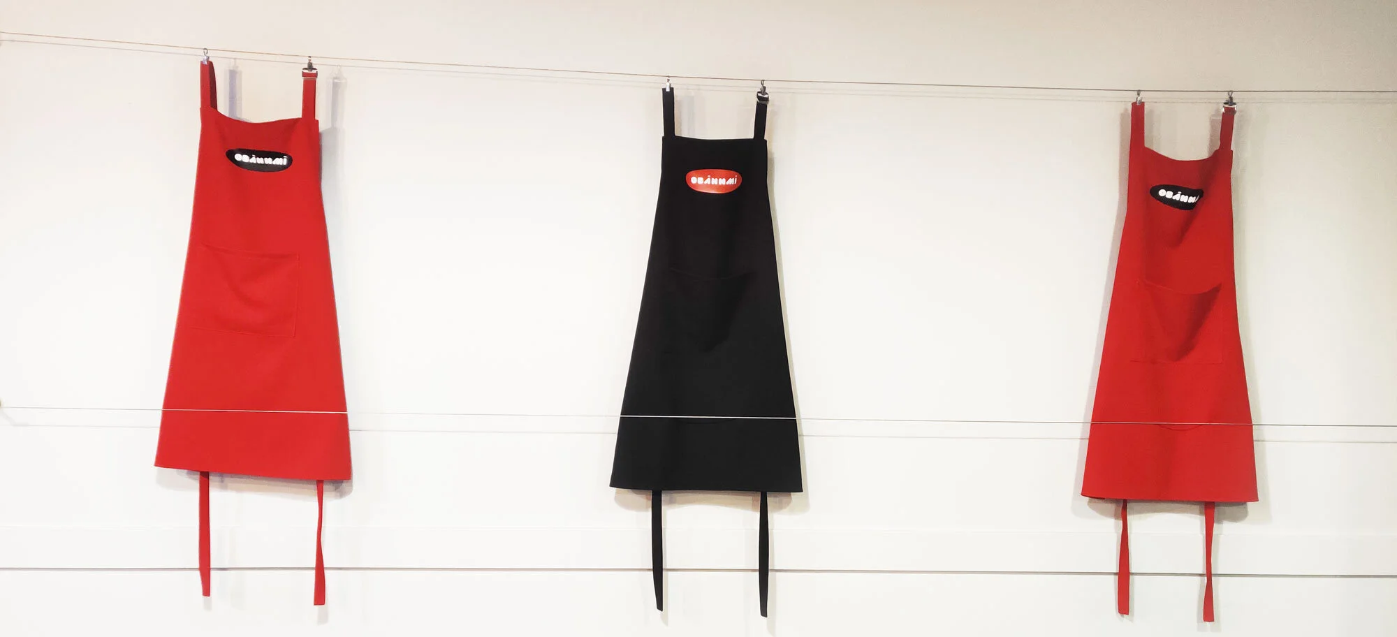 Red and black aprons hanging on the wall