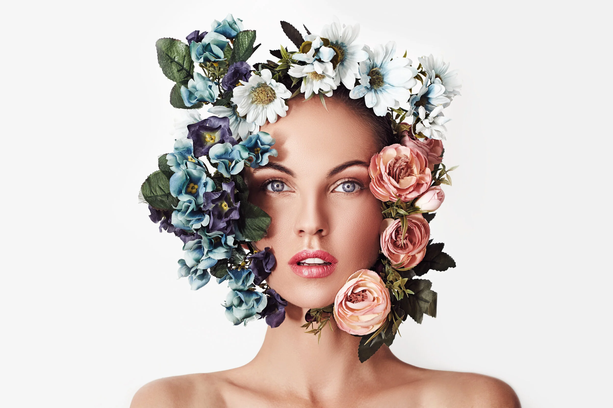 Portrait of a young beautiful woman with flowers on her head. Spring fashion photo. Skin care concept, beauty spa, bio product.