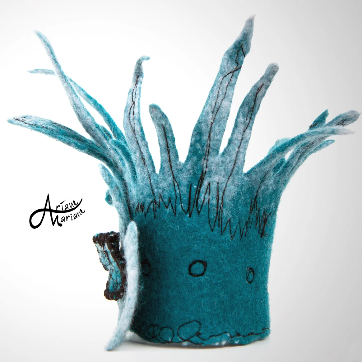 Spicy-sculptural-petrol-colored-armwarmer