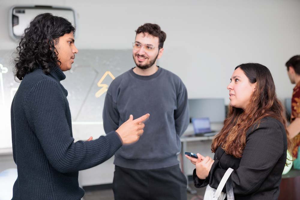 Two men and a woman speak together