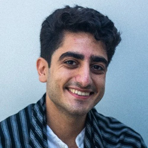 Alan Amin smiles facing the camera.