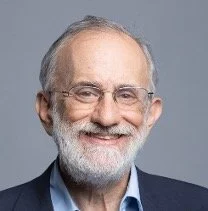 Joel S. Emer smiles facing the camera.