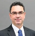 Emmanuel Planas smiles facing the camera.