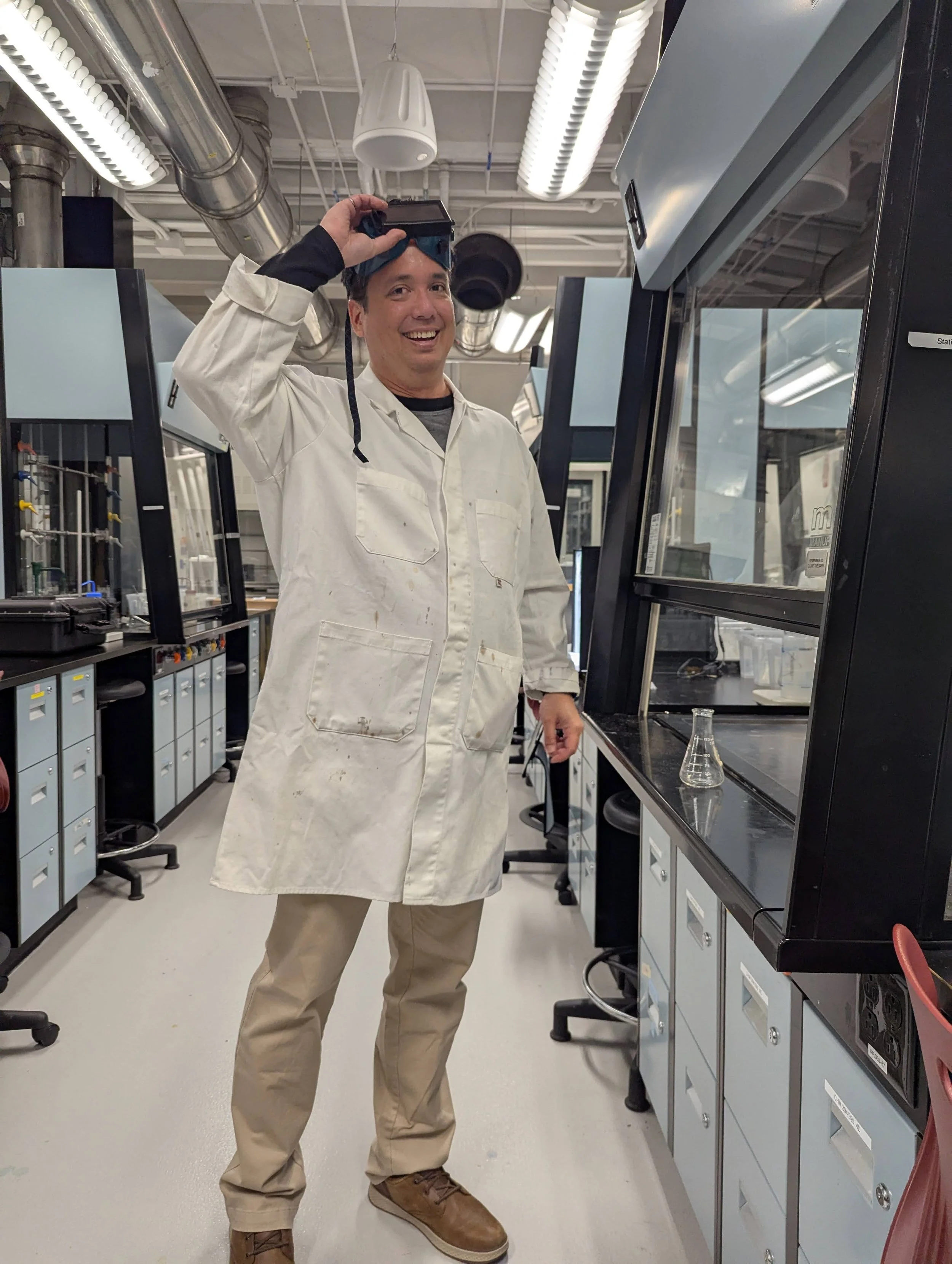 Steve Engels wearing a lab coat and goggles.