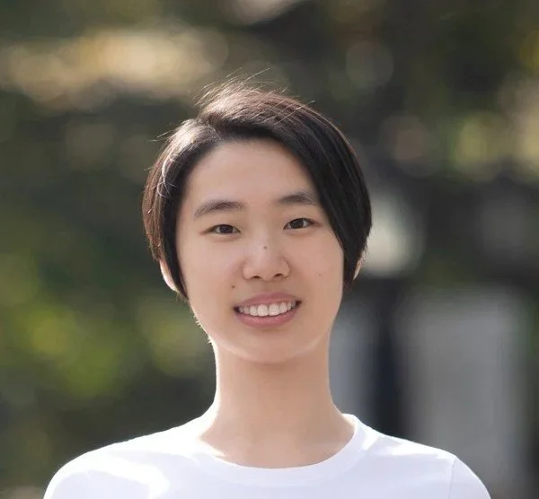 Zhijing Jin smiles facing the camera.