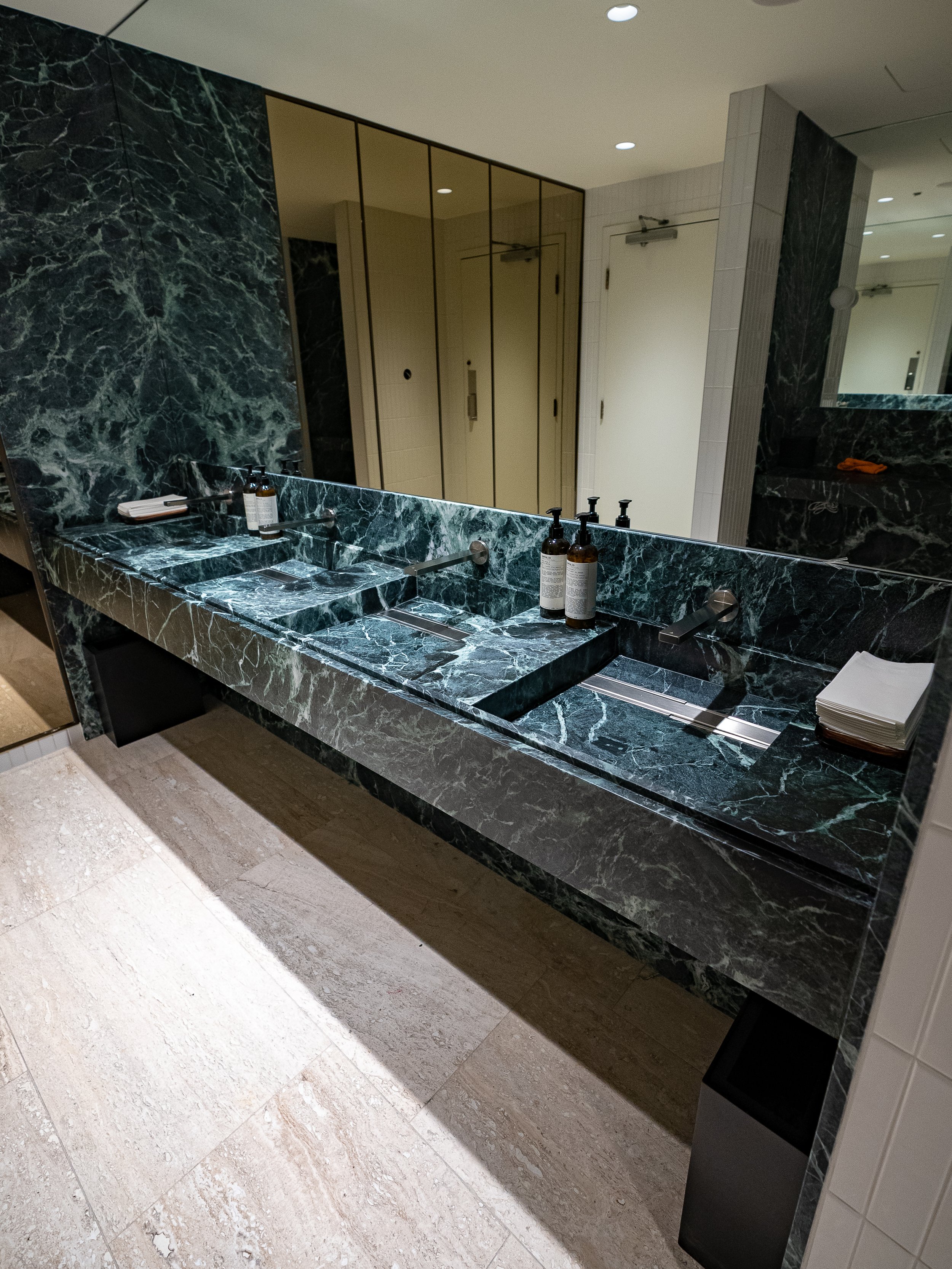  Stunning Italian Verde Alpi Marble vanities in Hotel Vogue are now preserved in honed PROSHIELD. 