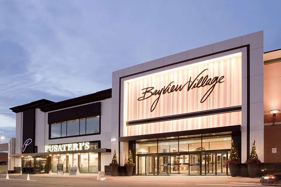 Exterior evening view of the upscale Bayview Village Shopping Centre entrance, home to Goa Indian Farm Kitchen in North York, Toronto.